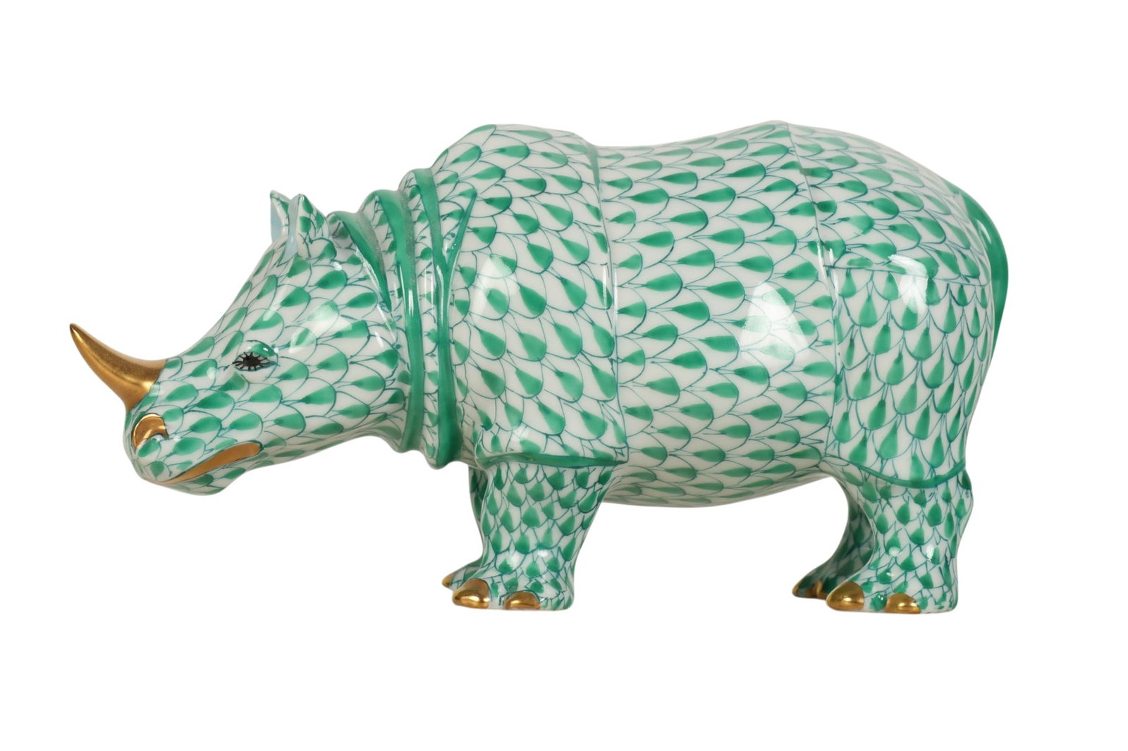 Herend Rhino Green Fishnet Porcelain 5" Figurine: Herend Hungary hand-painted porcelain rhinoceros figurine. Features the companys signature fish scale decoration in the Green Fishnet pattern. Finished with 24K gold gilt accents to the horn, nostrils