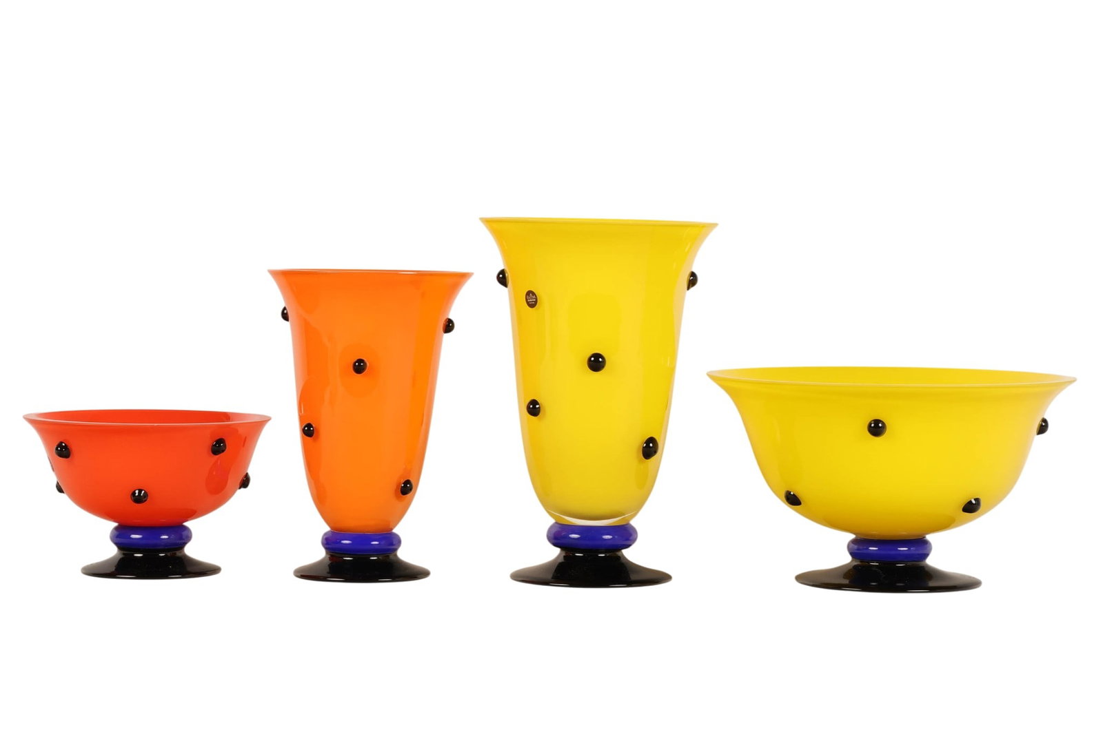 Rosenthal Studio Line Rot Beluga Art Glass 4pc LOT: Four-piece lot of Rosenthal Studio Line Rot Beluga art glass, including two bowls and two vases in vibrant yellow and orange tones with applied black glass prunts. Each piece is raised on a contrastin