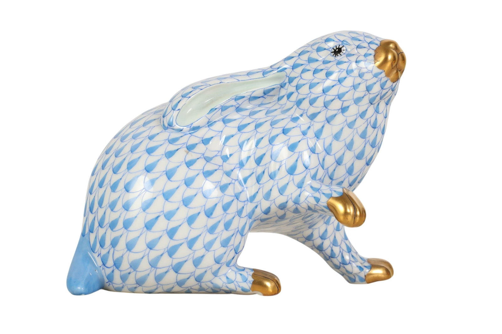 Herend Larger Bunny Blue Fishnet Porcelain Figure: Herend Hungary hand-painted porcelain large bunny figurine. Features the companys signature fish scale decoration in the Blue Fishnet pattern. Depicts a rabbit in a resting pose with one leg raised, t