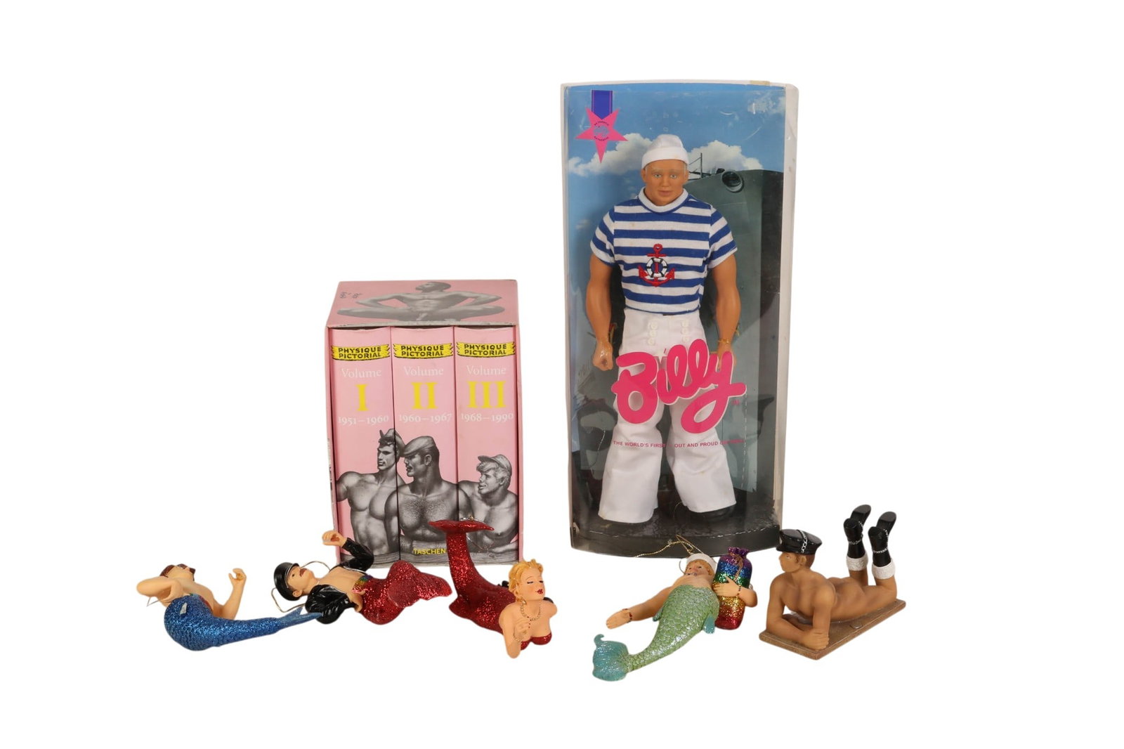 Billy Doll Physique Pictorial Gay Erotica and More: Totem International, Billy doll titled "The World's First Out and Proud Gay Doll" featuring a sailor outfit with striped shirt and white trousers housed in display packaging with printed graphics and 