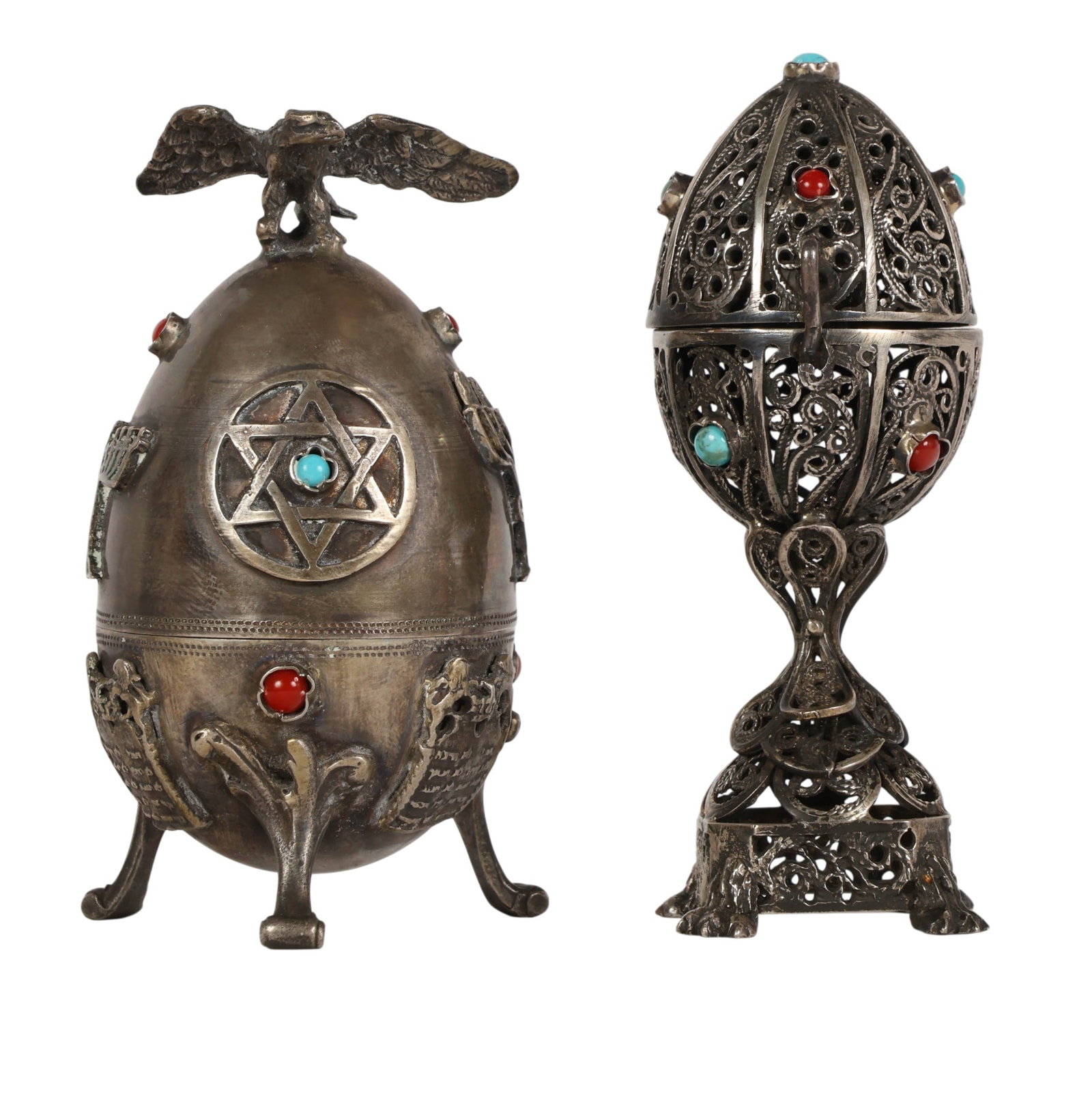 Russian 84 Silver Jewish Judaica Eggs w Gemstones: Lot of two Russian 84 silver decorative egg form boxes. One example featuring openwork filigree decoration accented with turquoise and coral cabochons, fitted with a hinged cover and raised on an orna
