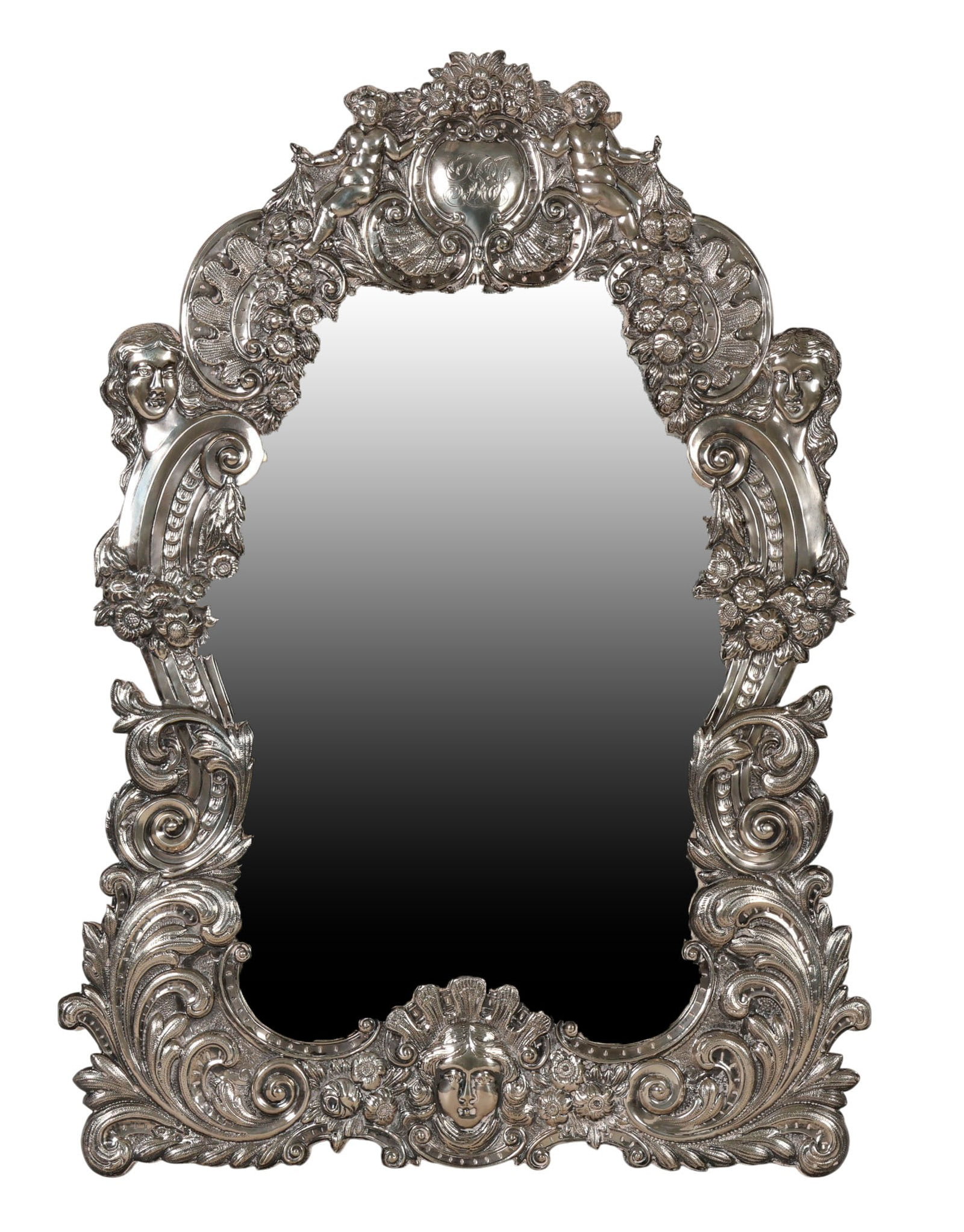 Victorian Sterling Silver Repousse Dresser Mirror: Antique English Victorian sterling silver-clad tabletop mirror featuring an ornate Rococo Revival deeply cast frame with elaborate scrolling foliate, figural, and cherub accents throughout. The shaped