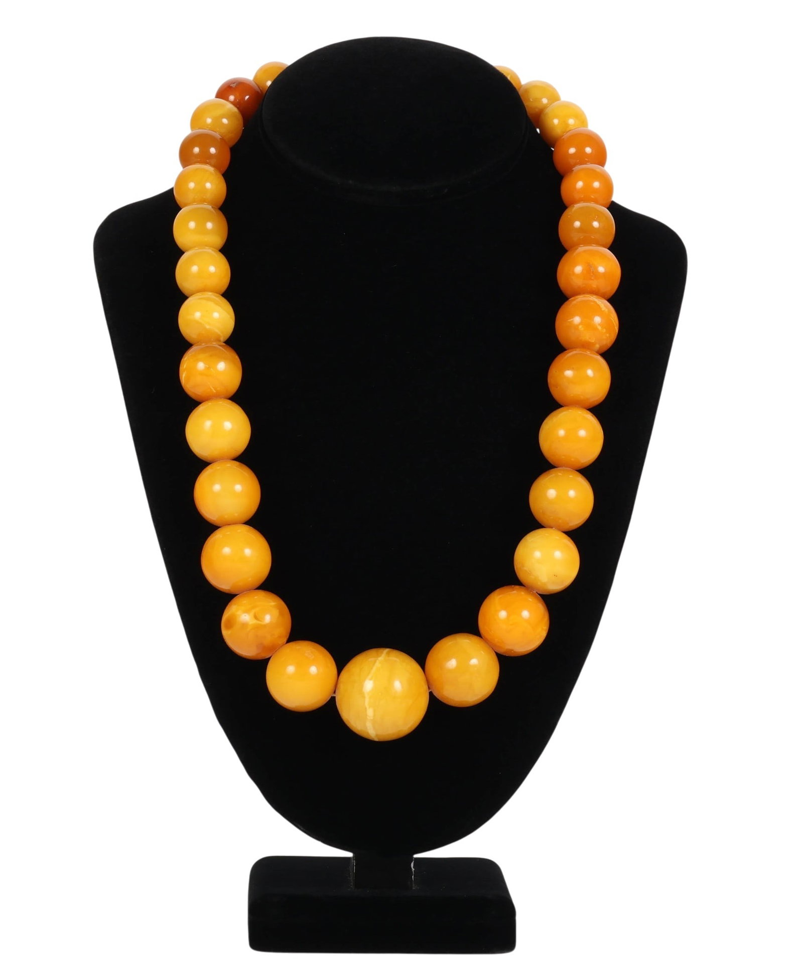 Butterscotch Eggyolk Graduated Amber Necklace 120g: Single strand beaded necklace featuring polished graduated spheres in blended butterscotch, egg yolk, honey, and caramel tones with natural marbling. Finished with a simple clasp closure. No apparent
