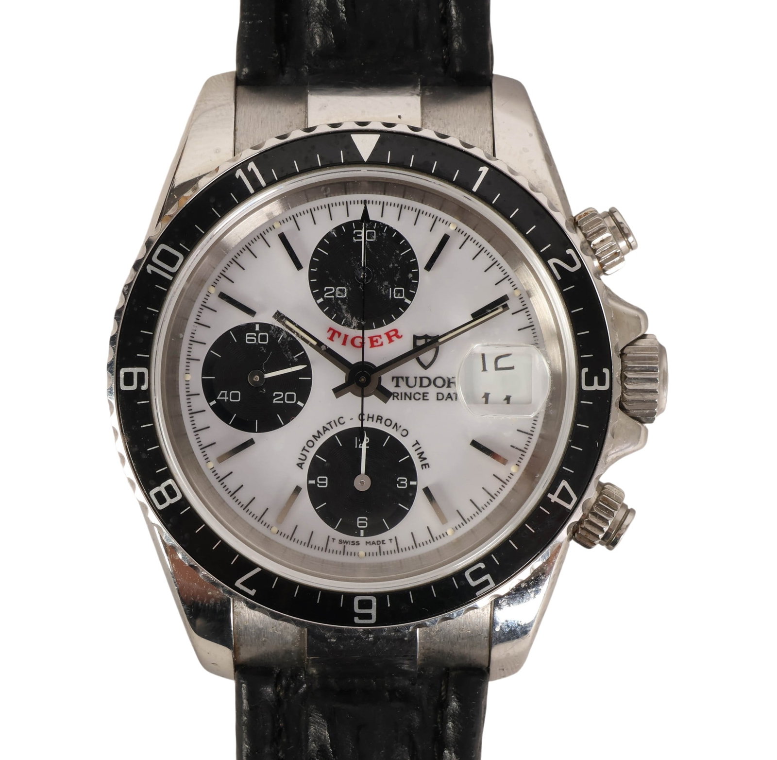 Tudor Prince Date Tiger Chronograph Watch with Box: Tudor Prince Date Tiger chronograph wristwatch featuring a stainless steel case with black bezel and white dial with three subdials and date display. Powered by an automatic movement. Case measures ap