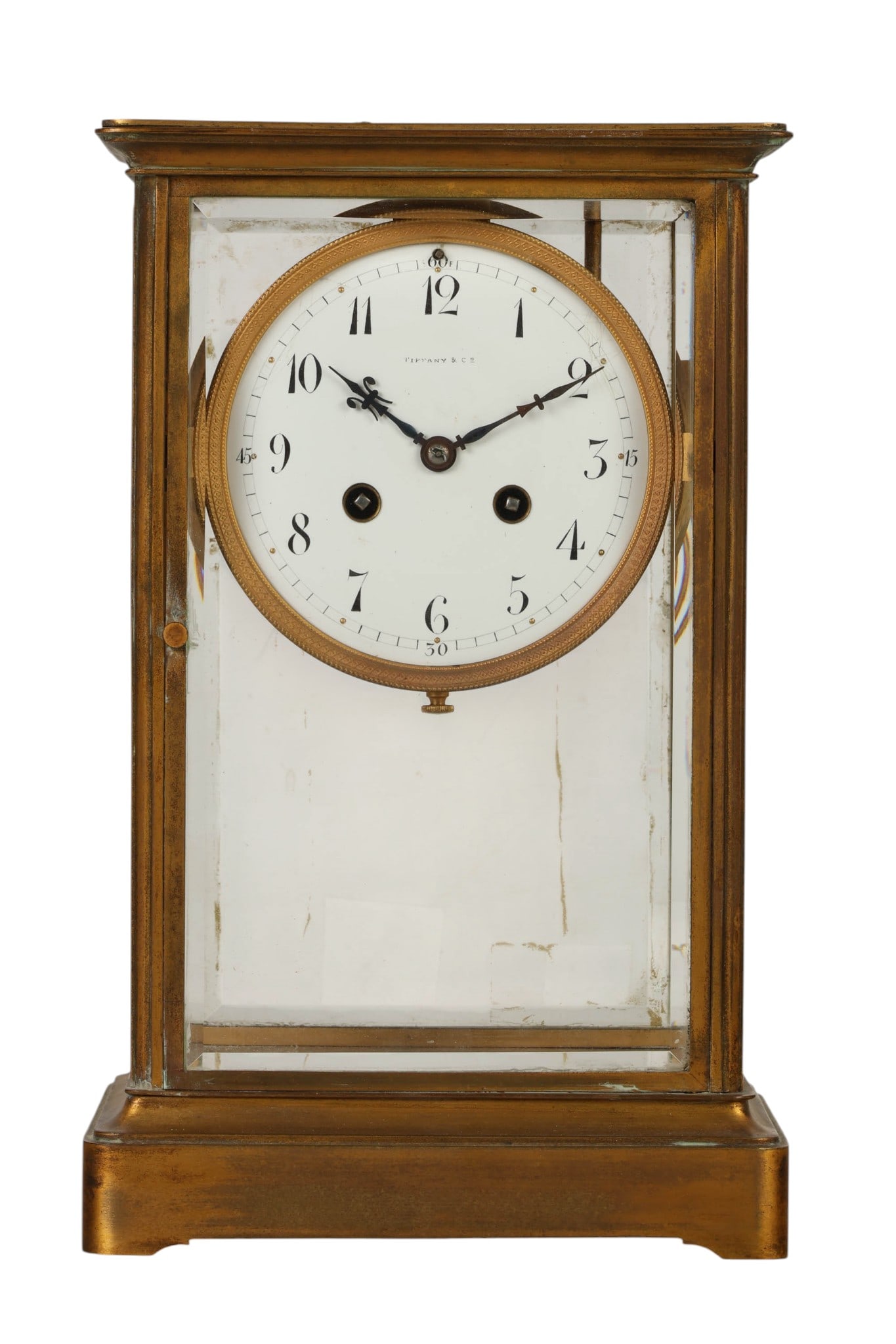 Tiffany Co Bronze and Glass Carriage Mantel Clock: Tiffany and Co. antique French bronze and glass carriage clock featuring a rectangular case with beveled glass panels and a white enamel dial with Arabic numerals. The movement marked Tiffany and Co a