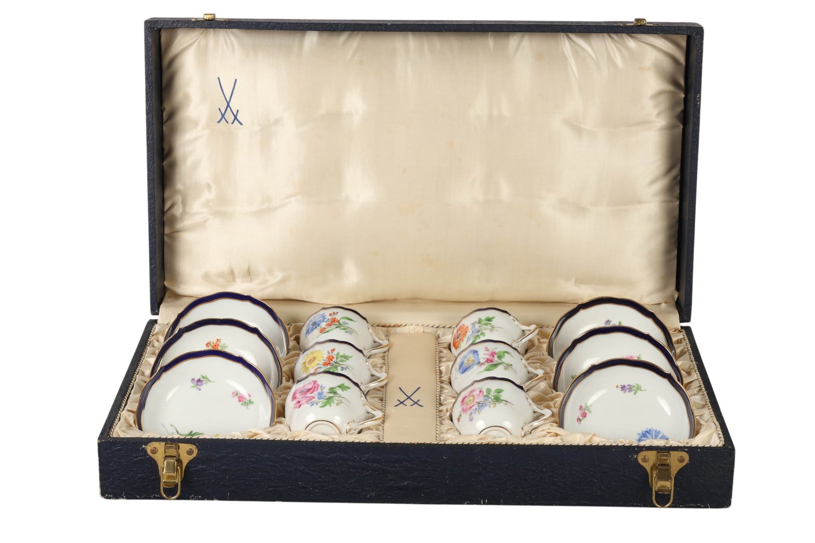 Meissen Floral Demitasse Cups & Saucers with Case: Meissen porcelain set of six demitasse cups with matching saucers, each decorated with hand painted floral sprays in polychrome enamels accented by cobalt blue borders and gilt trim. Cups feature shap