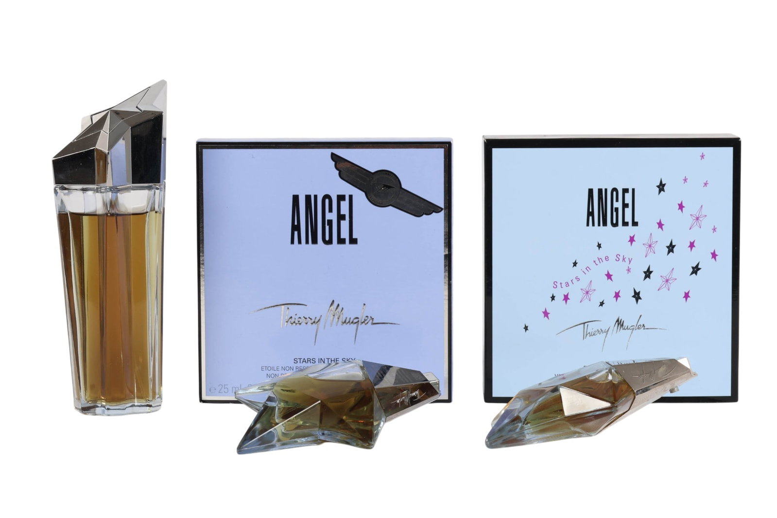 Thierry Mugler Angel Stars in the Sky Set 5pc LOT: Thierry Mugler Angel Stars in the Sky eau de parfum five piece assortment. Comprising a tall star shaped flacon with silver tone cap, two miniature star form examples, and branded packaging. Includes 