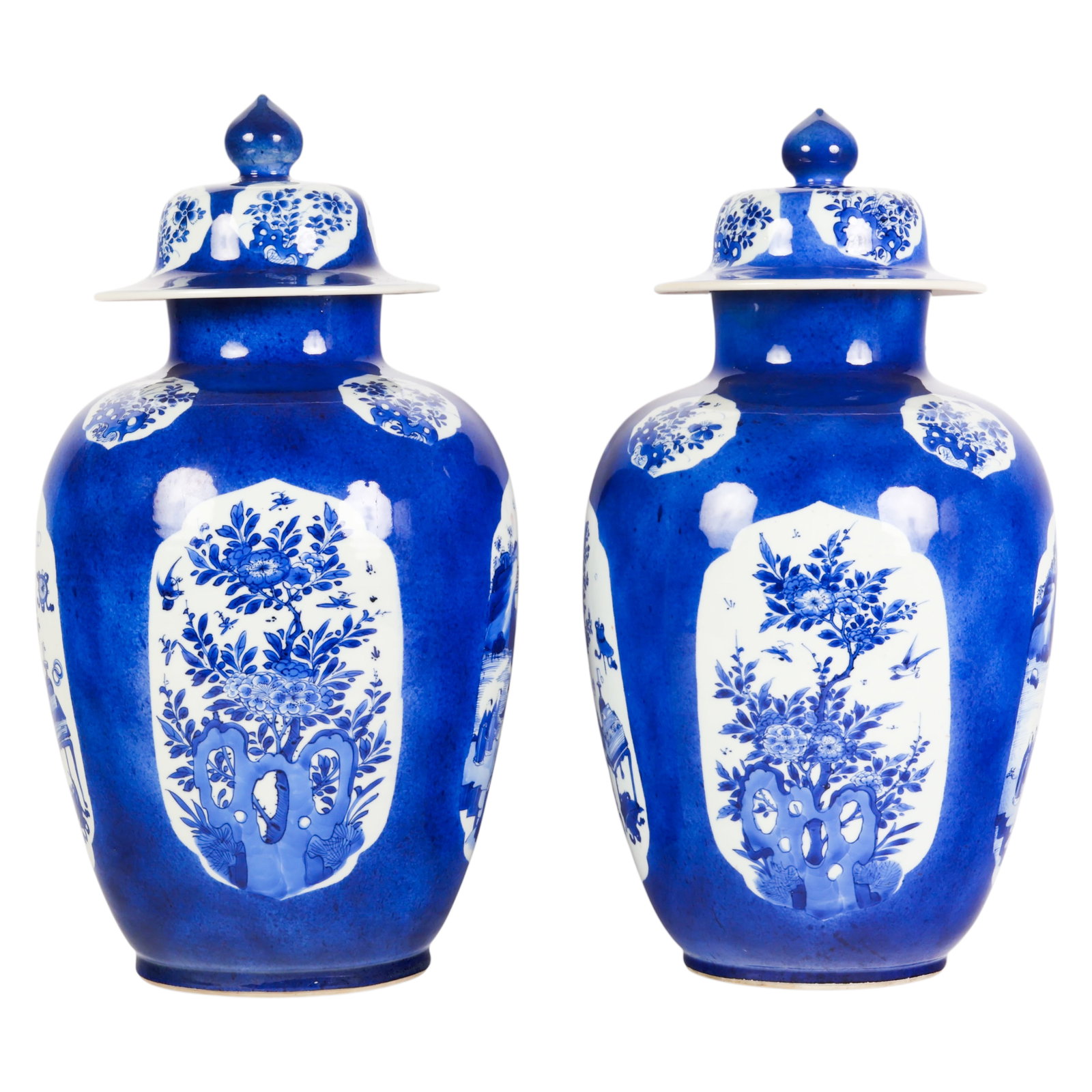 Chinese Pair Antique Blue and White Covered Vases: Pair of Chinese porcelain covered baluster-form jars decorated in cobalt blue and white enamels. Each vessel features shaped reserves enclosing floral, bird, and landscape motifs against a rich mottle