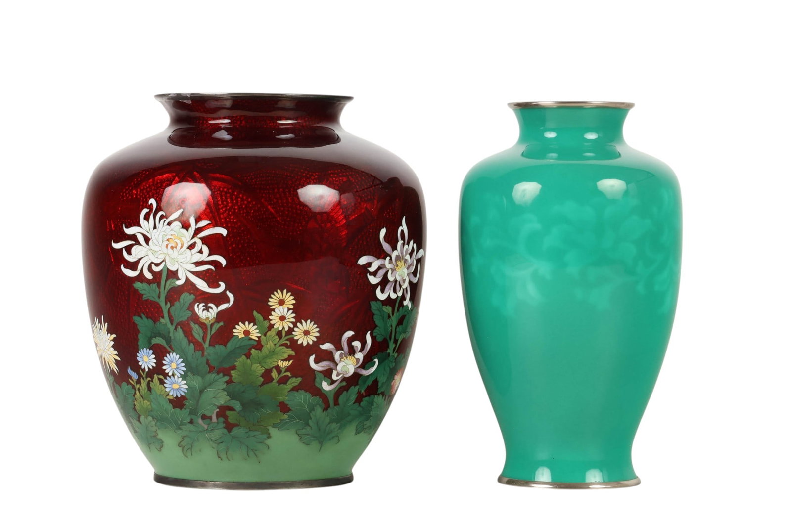 Japanese Cloisonne Green & Red Chrysanthemum Vase: Japanese cloisonne enamel vases, two examples with silver rims. One baluster form with burgundy ground decorated with chrysanthemum and foliage measuring approximately 7.5 H x 6.5 W x 6.5 D. One with 
