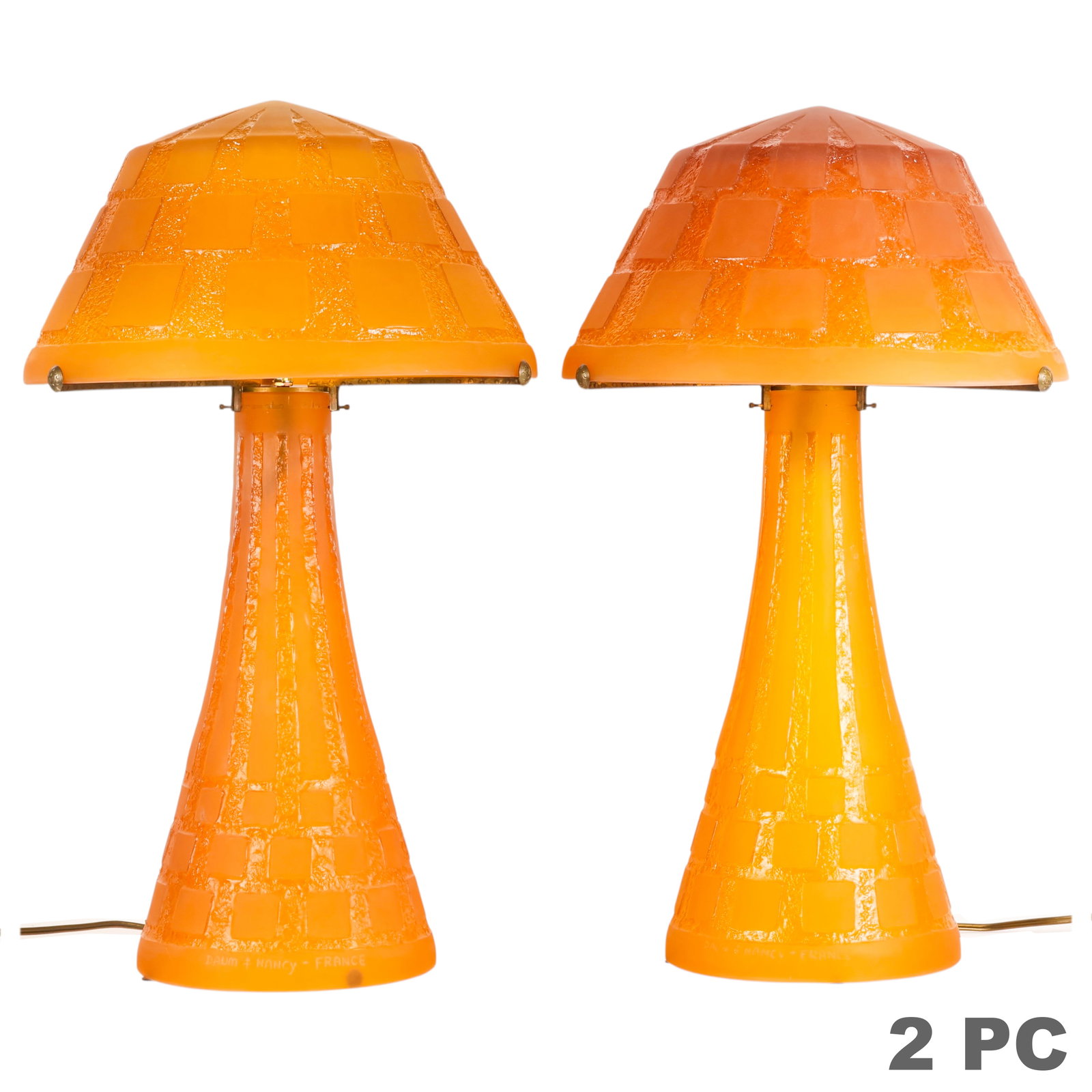 Daum Nancy Pair of Pate de Verre Amber Glass Lamps: Pair of Daum Nancy French Art Deco amber pate-de-verre glass table lamps, executed entirely in molded amber glass. Each lamp features a matching geometric Art Deco paneled shade above a tapered column