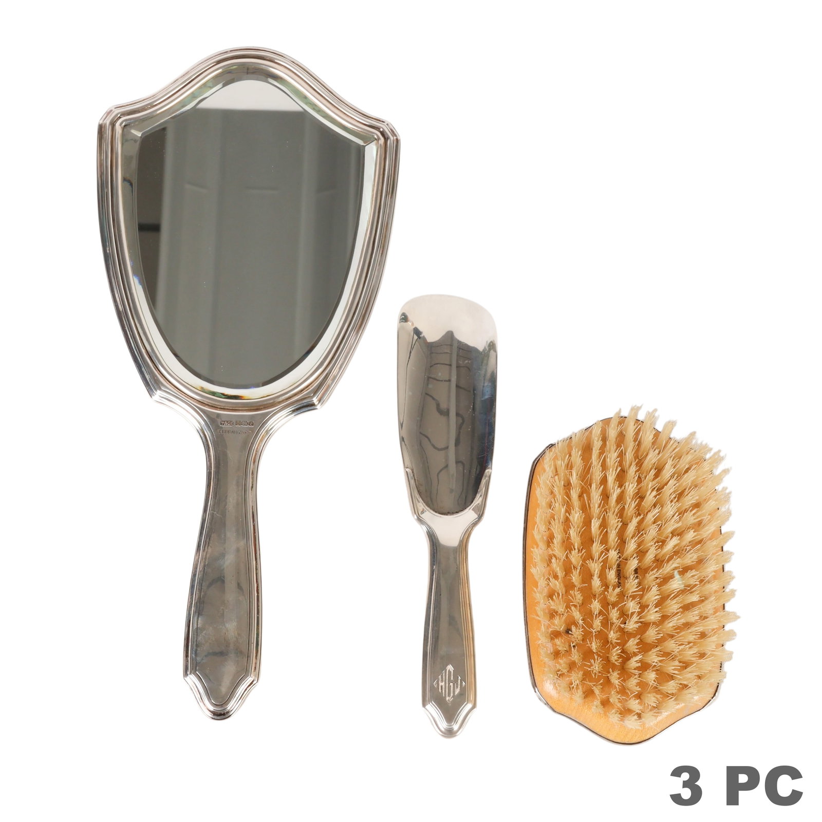 Tiffany & Co Makers Sterling Silver 3pc Vanity SET: Antique Tiffany & Co. Makers sterling silver vanity set comprising a hand mirror, hairbrush, and shoe horn, each featuring an engraved monogram and marked "Tiffany & Co. Makers Sterling." Accompanied 