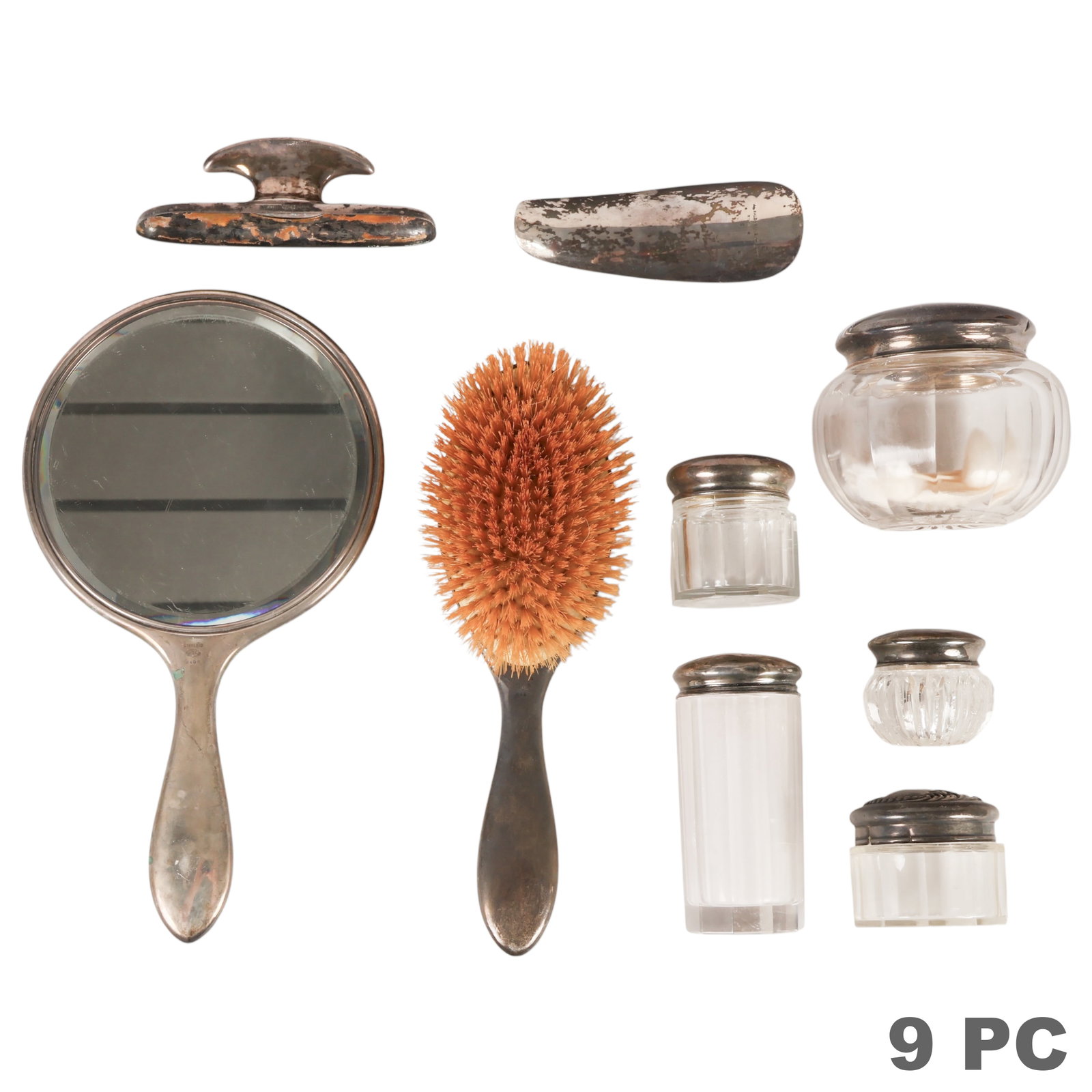 Sterling Glass Victorian Vanity Items 9pc LOT: Victorian sterling silver vanity group comprising nine pieces, including a monogrammed hand mirror, hair brush, handled brush, shoehorn, two glass vanity jars with sterling silver lids, a sterling sil