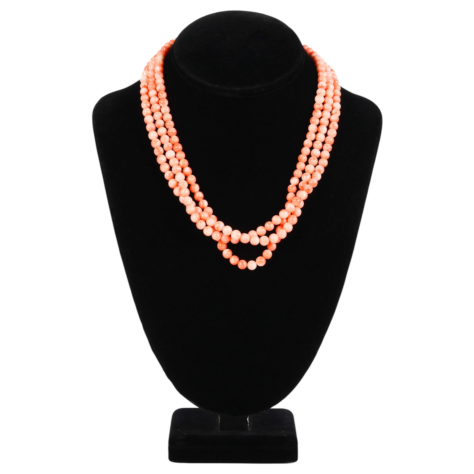 18k Clasp 3 Strand Angel Skin Coral Bead Necklace: Vintage triple-strand angel skin coral bead necklace featuring natural pale pink and peach-salmon hues. The necklace is composed of polished coral beads strung on silk in a triple-strand design and co