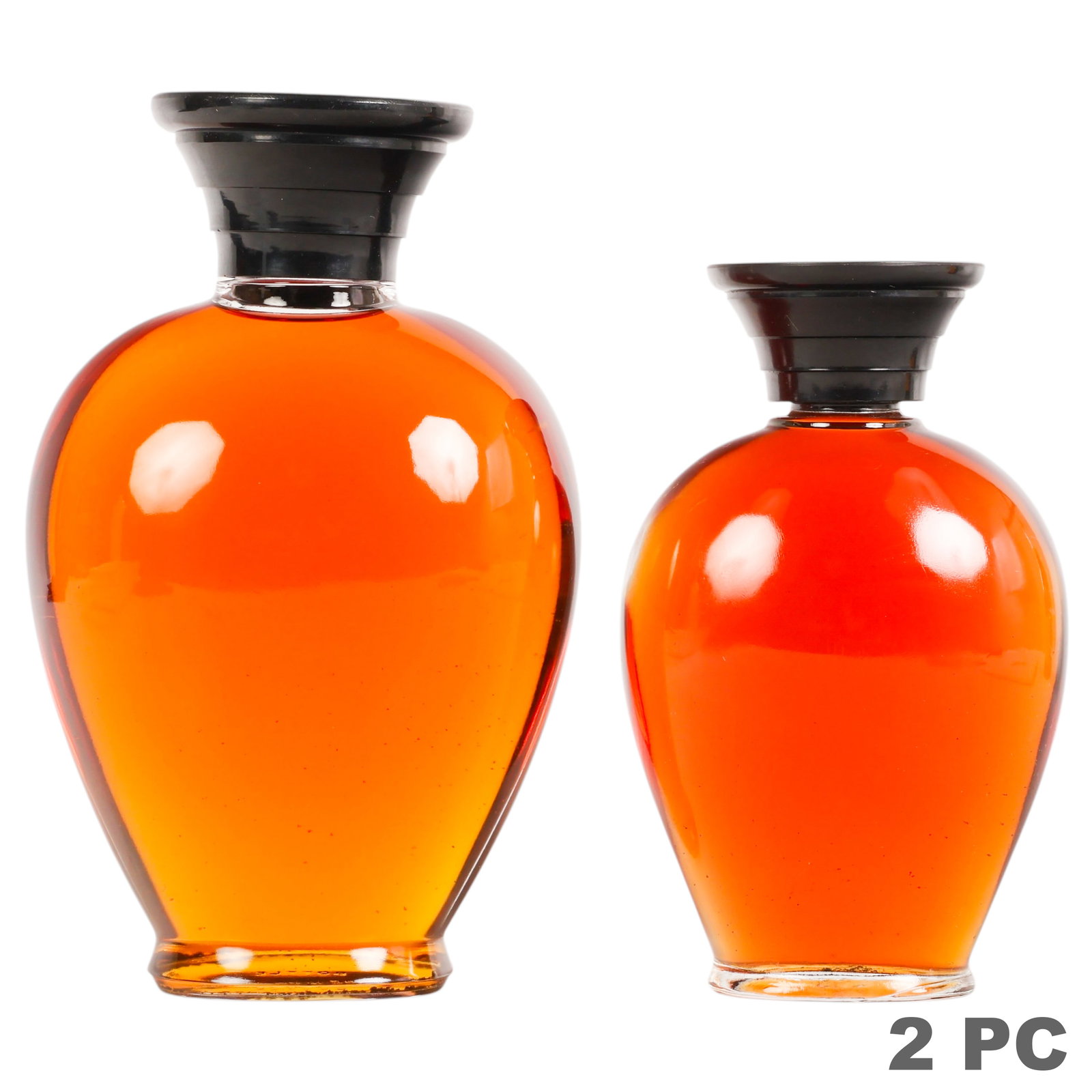 Vintage Rochas Femme Eau de Cologne Bottles 2pc: Two vintage Rochas Femme Eau de Cologne bottles, each featuring the iconic curvaceous amber glass form designed by Marcel Rochas and fitted with black stoppers embossed "Marcel Rochas Paris." Both bot