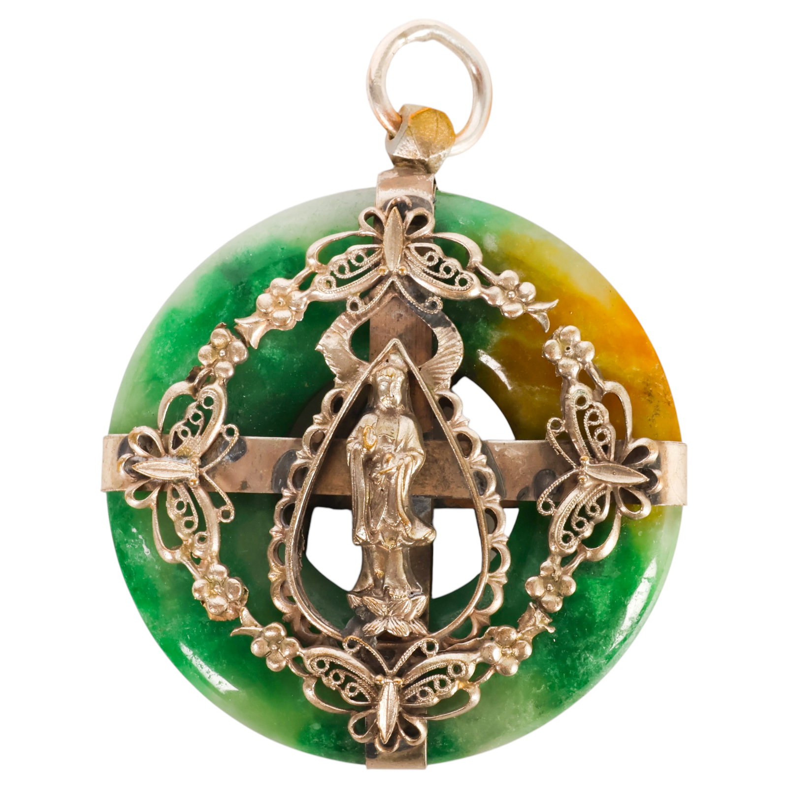 Chinese 20C. Jade Bi Disc Filigree Guanyin Pendant: Chinese jade bi disc pendant featuring a carved mottled green and russet jade bi-form disc mounted within an ornate silvered metal filigree frame. The mount is decorated with butterflies, blossoms, an