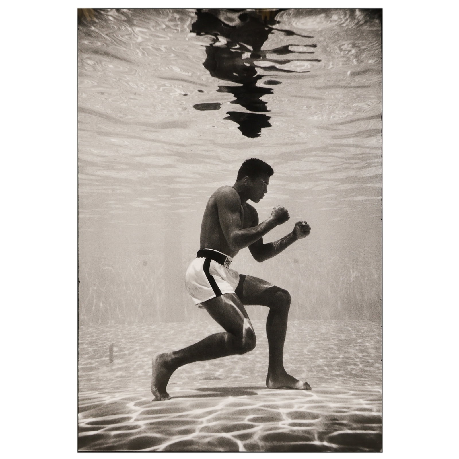 Flip Schulke 1930-2008 Ali Underwater Photograph: Flip Schulke (American, 1930-2008), Ali Underwater, 1961, silver gelatin photograph depicting Muhammad Ali in a boxing stance beneath the surface of a swimming pool, one of the most recognizable image