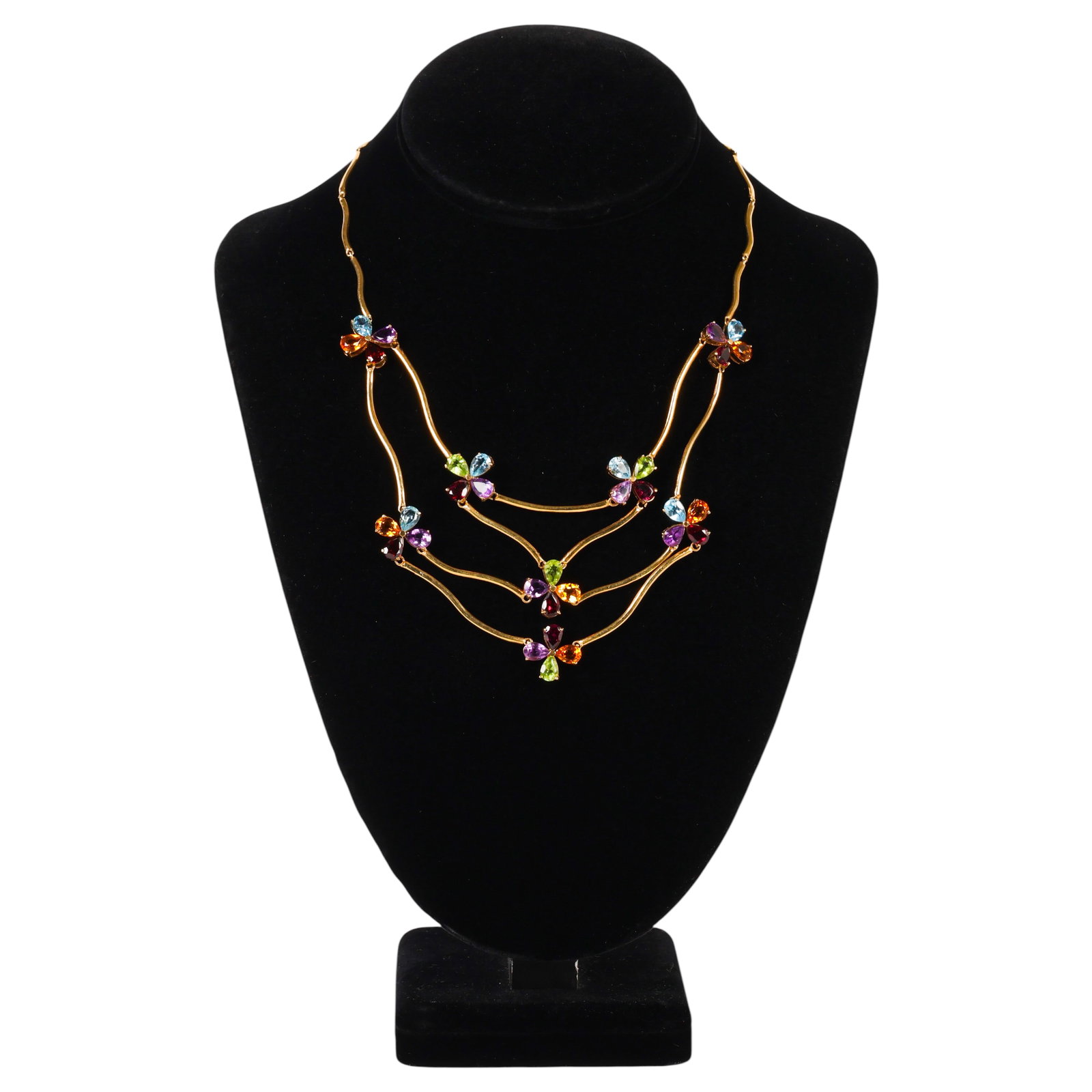 18K Gold Multi-Gemstone Flower Bib Necklace 23g.: 18K yellow gold multi-strand bib necklace featuring articulated yellow gold links accented by floral clusters of faceted pear-shaped gemstones, including blue topaz, amethyst, garnet, citrine, and per