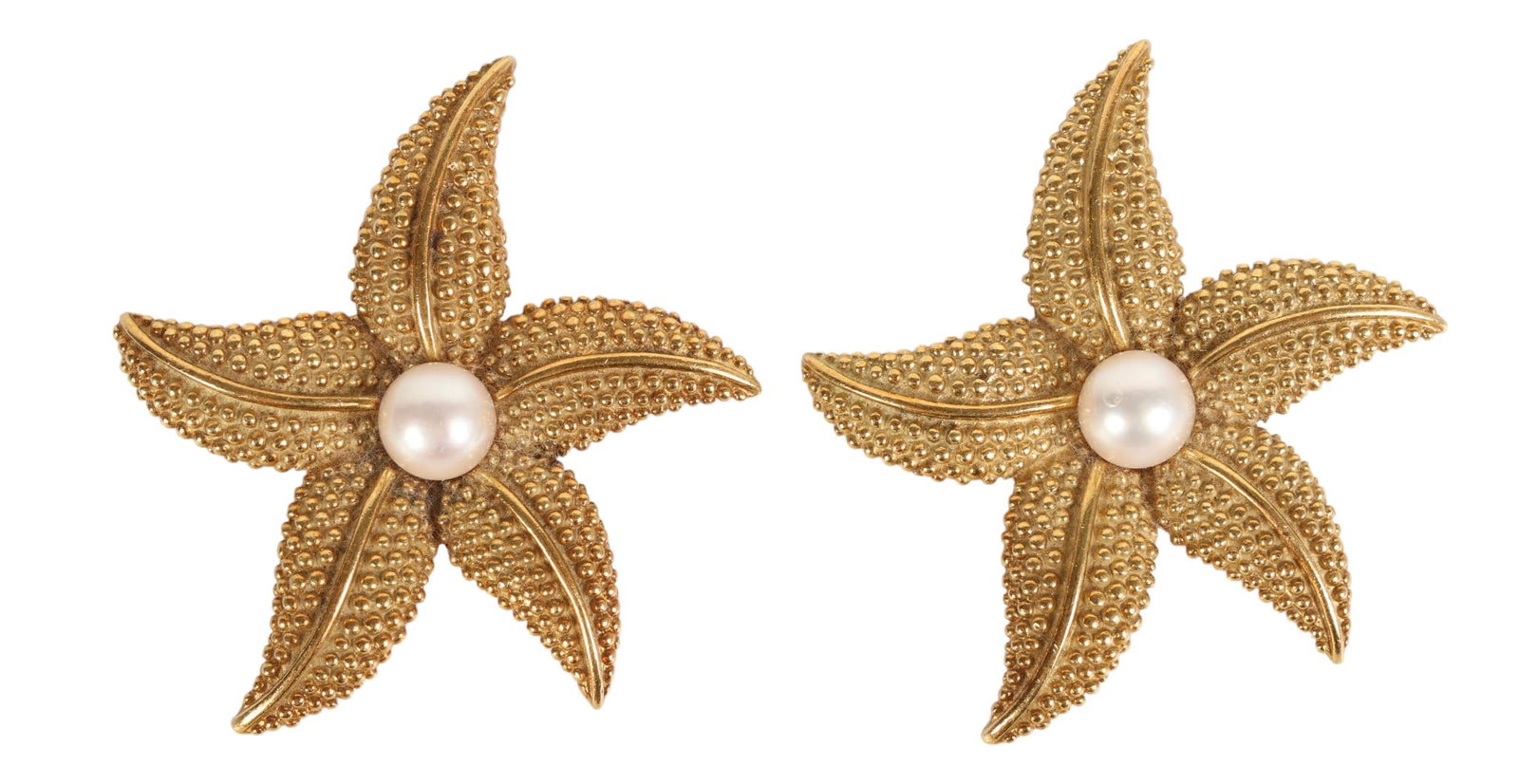 18k Yellow Gold Pearl Pair Starfish Brooches 34.5g: Pair of 18K yellow gold cultured pearl starfish pins. Each designed with textured, beaded surfaces and softly contoured arms, centered with a cultured pearl measuring approximately 7.2 mm. Measuring a