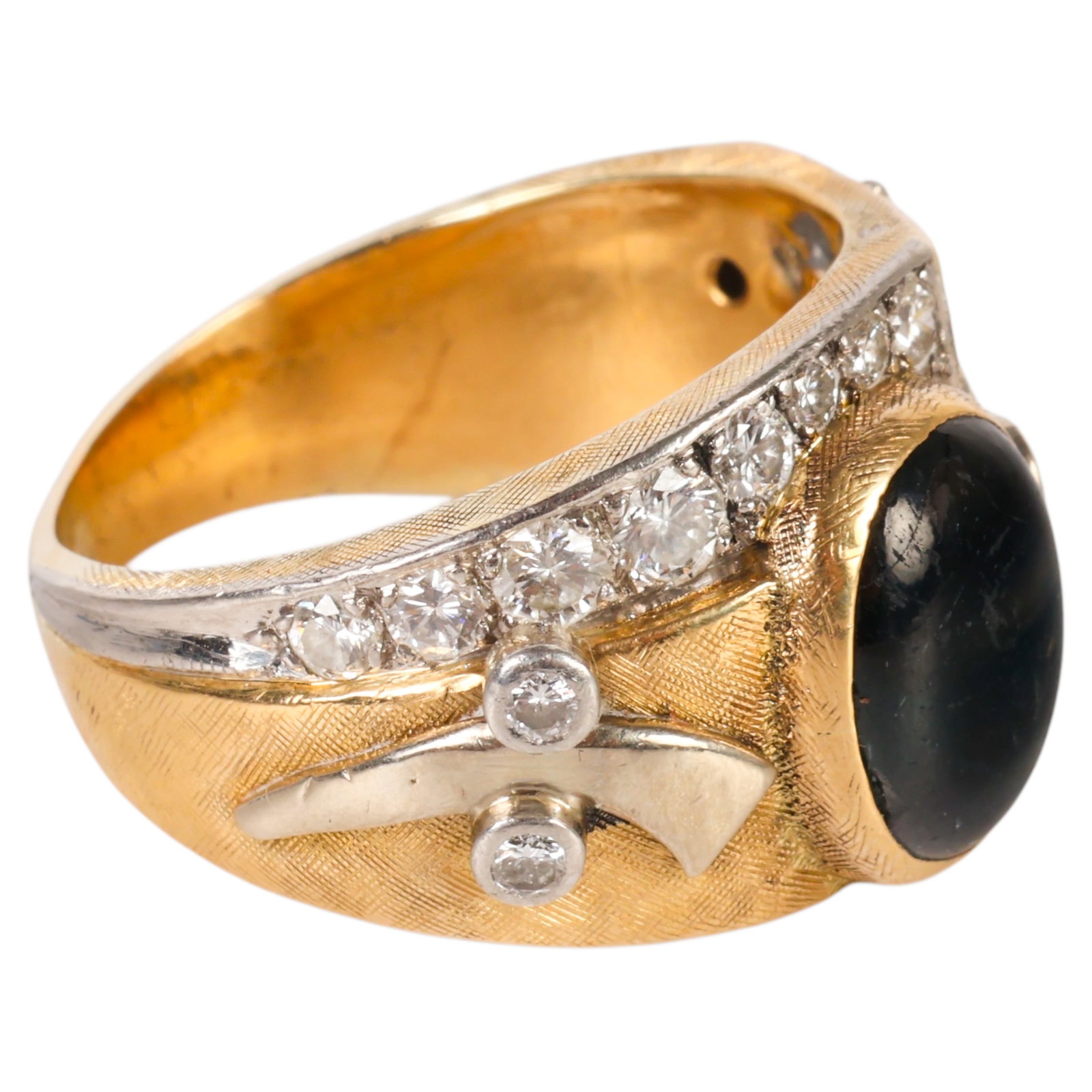 18K Gold Masonic Ring with Sapphire and Diamonds: 18K yellow gold Masonic ring featuring a central oval cabochon dark grayish blue sapphire measuring approximately 11 x 9 mm and weighing approximately 5.5 carats. The ring is accented by approximately