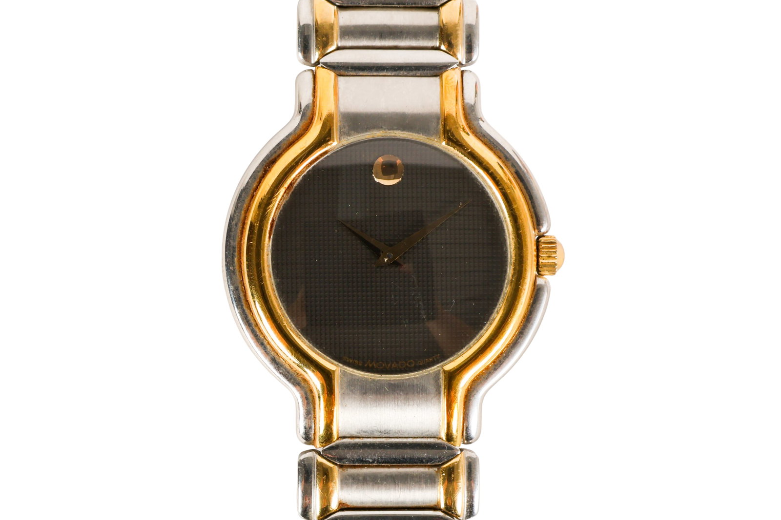 Movado Gentlemans Vintage Two Tone Wristwatch: Movado men's mid-size wristwatch featuring a metallic dial with the iconic single dot at the 12 o'clock position, gold-tone bezel accents, and a two-tone stainless steel bracelet. Case back marked "81
