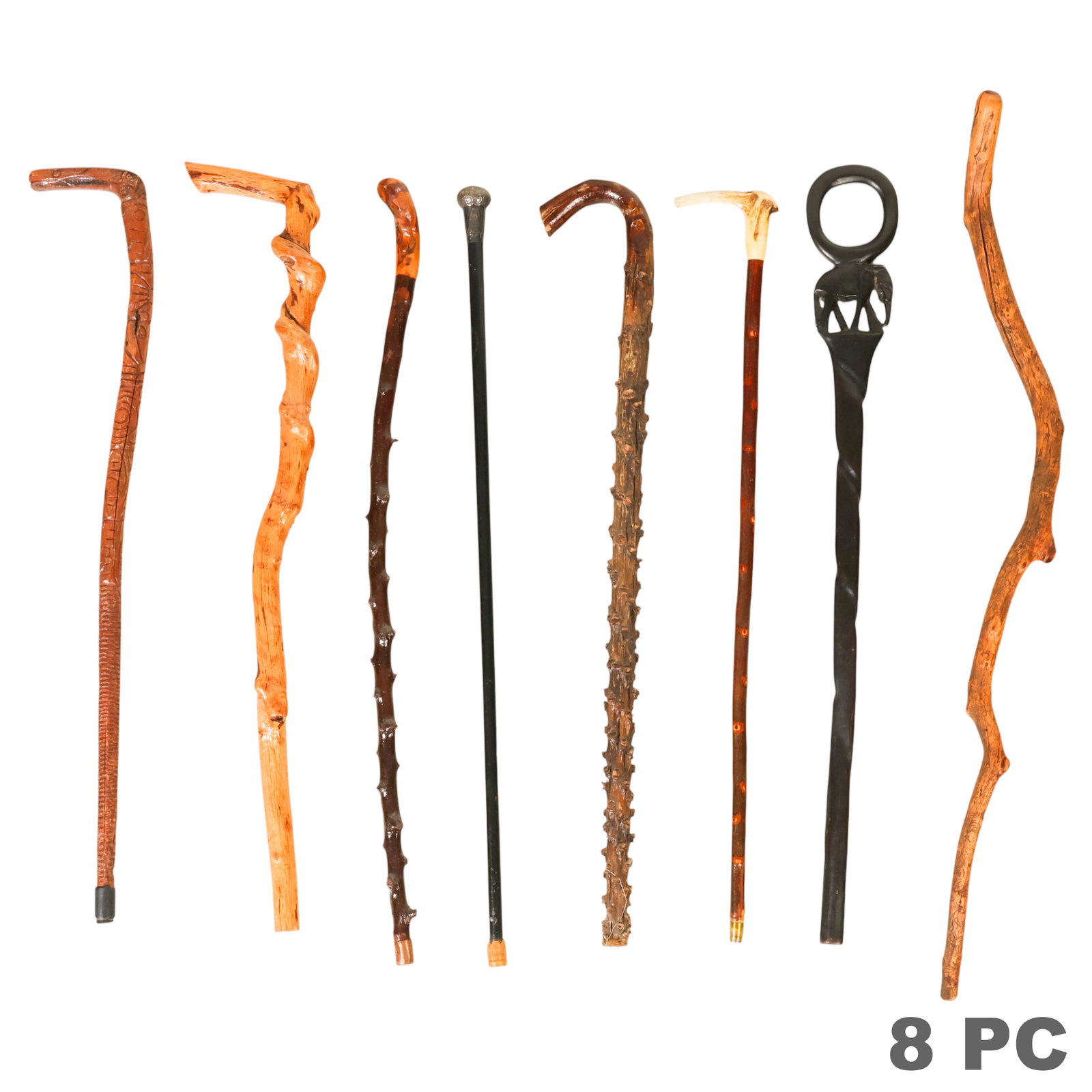 Vintage Wood and Organic Canes Walking Stick LOT: Eight walking sticks and canes comprising examples fashioned from natural branch wood, carved hardwood, and polished wood shafts. Included are a black walking cane with an engraved English sterling si