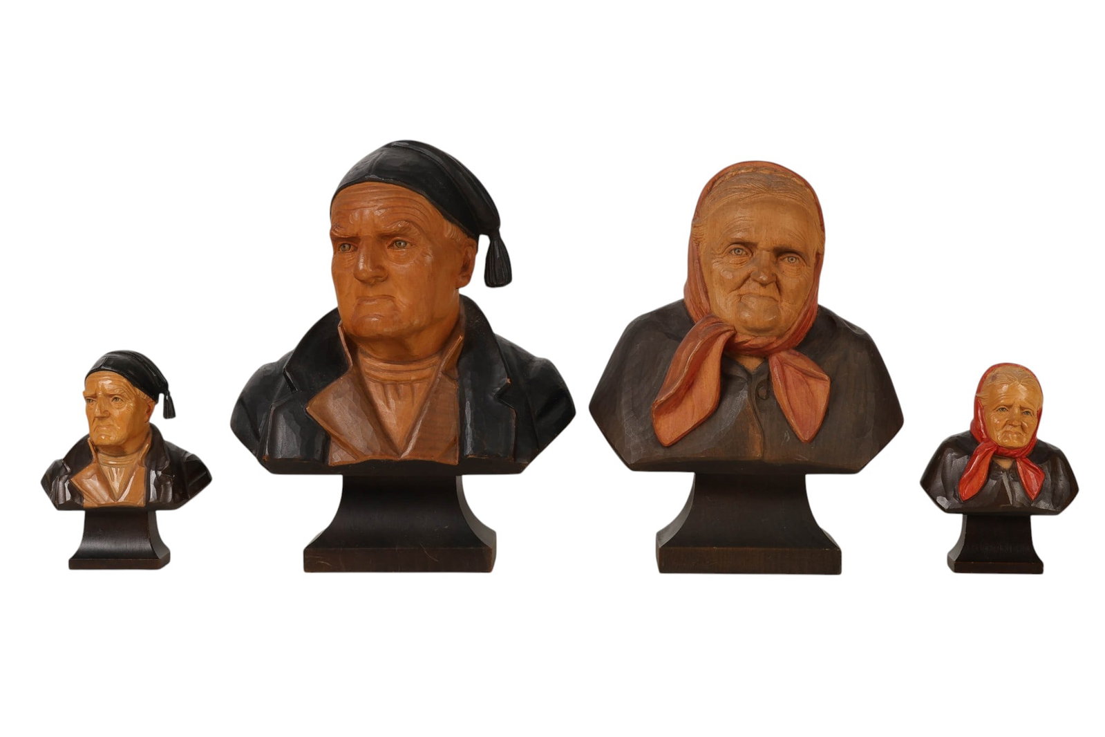 Hans Huggler Wyss Swiss Carved Wood Busts 4pc LOT: Lot of four hand-carved and polychrome-painted wood figural busts attributed to Hans Hugler-Wyss (Swiss, 1877-1947). The group depicts expressive male and female figures in traditional Swiss attire, i