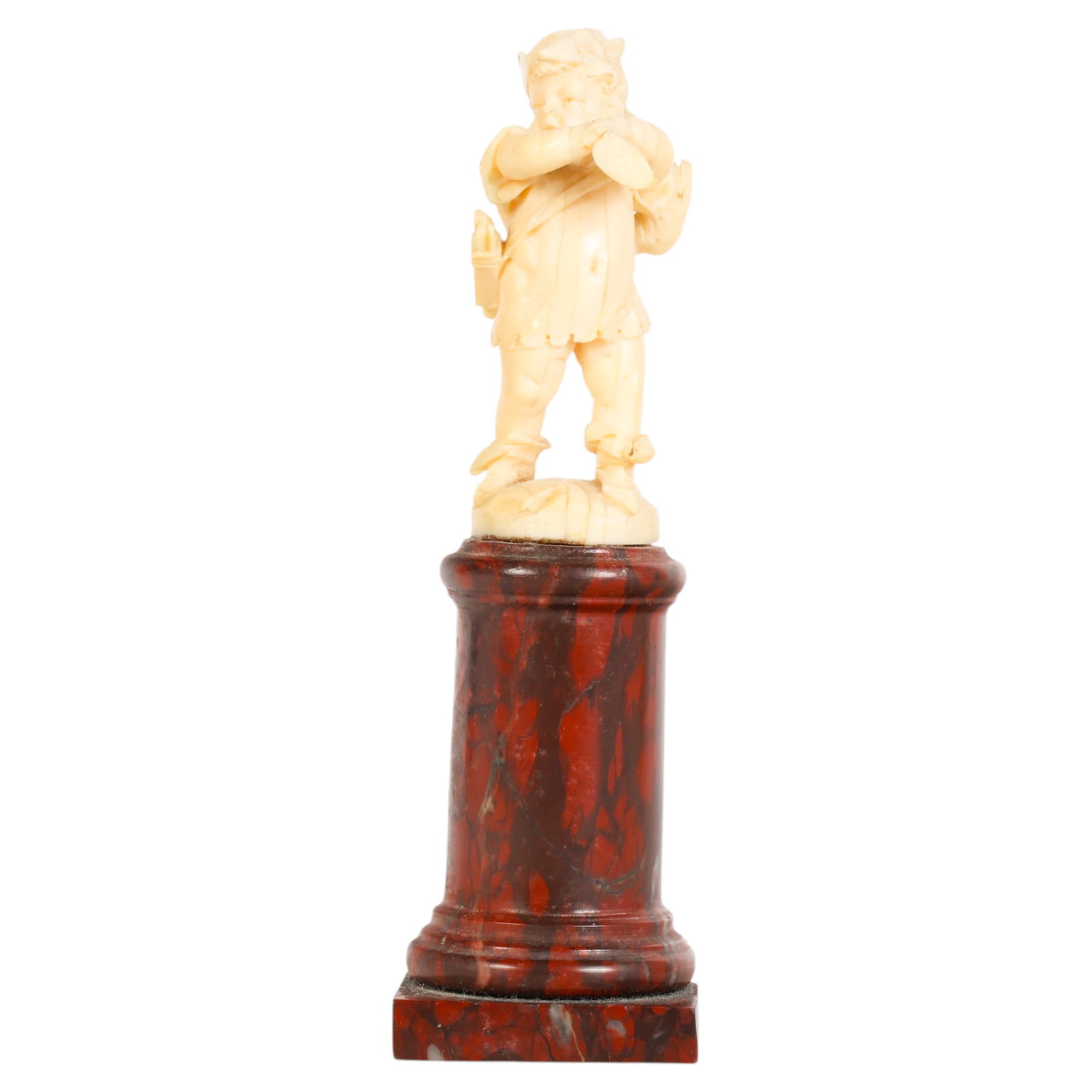 Antique Carved Putto Figurine on Marble Pedestal: Antique figure carved from organic material, depicting a standing putto or cherub in Renaissance-style attire, shown carrying hunting game and a pheasant draped over one shoulder. The finely detailed 
