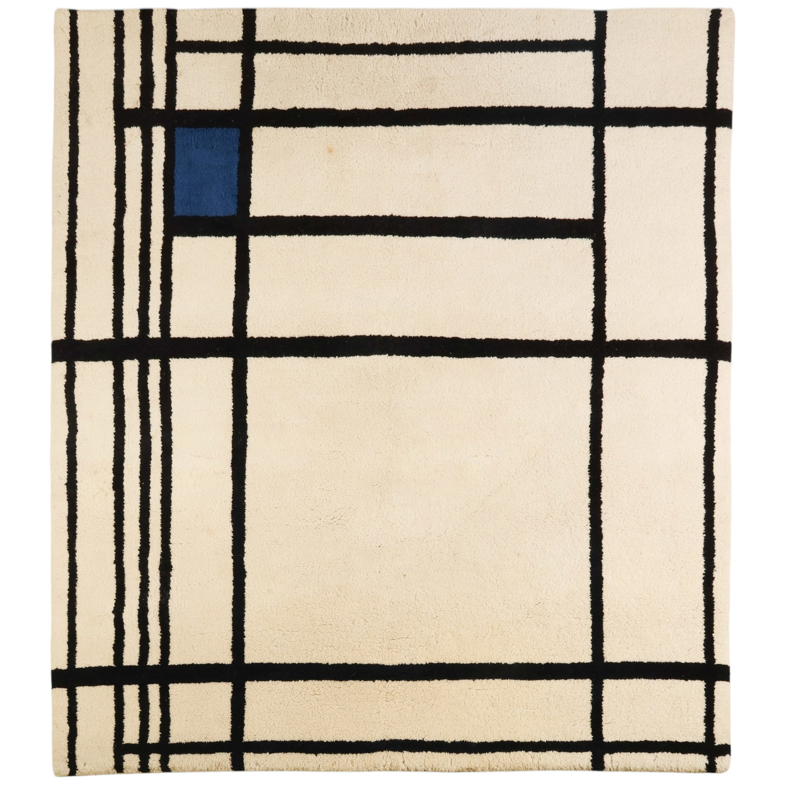 Mondrian Style Hand Made Wool Carpet Wall Hanging: Modernist Mondrian-style hand-knotted wool pile carpet or wall hanging featuring a geometric composition with a cream field intersected by black linear gridwork and accented by a single blue square in