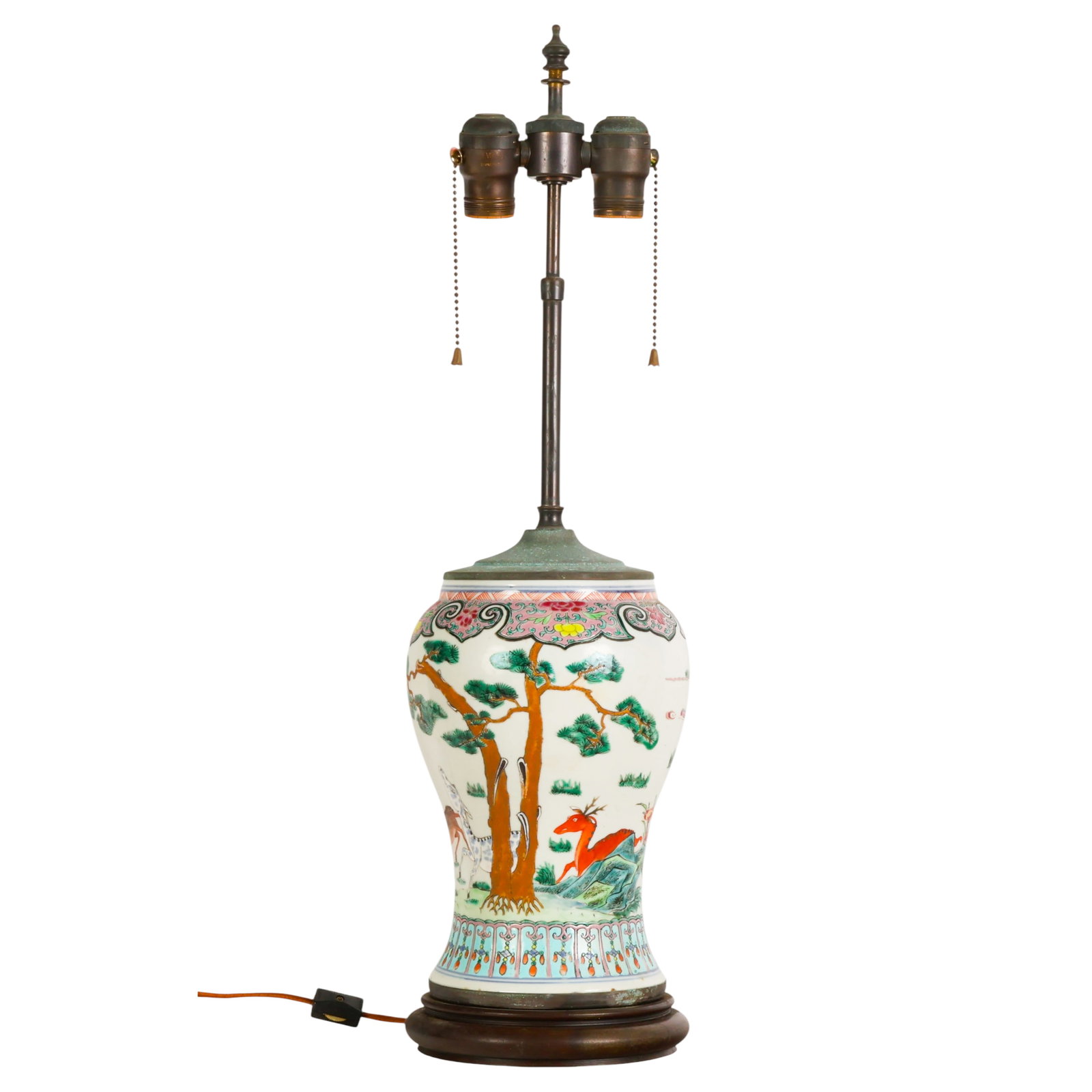 Chinese Export Famille Rose Porcelain Vase Lamp: Chinese famille rose porcelain vase converted to a table lamp, decorated with a continuous hand painted landscape scene featuring deer and other animals beneath pine trees, stylized clouds, and orname