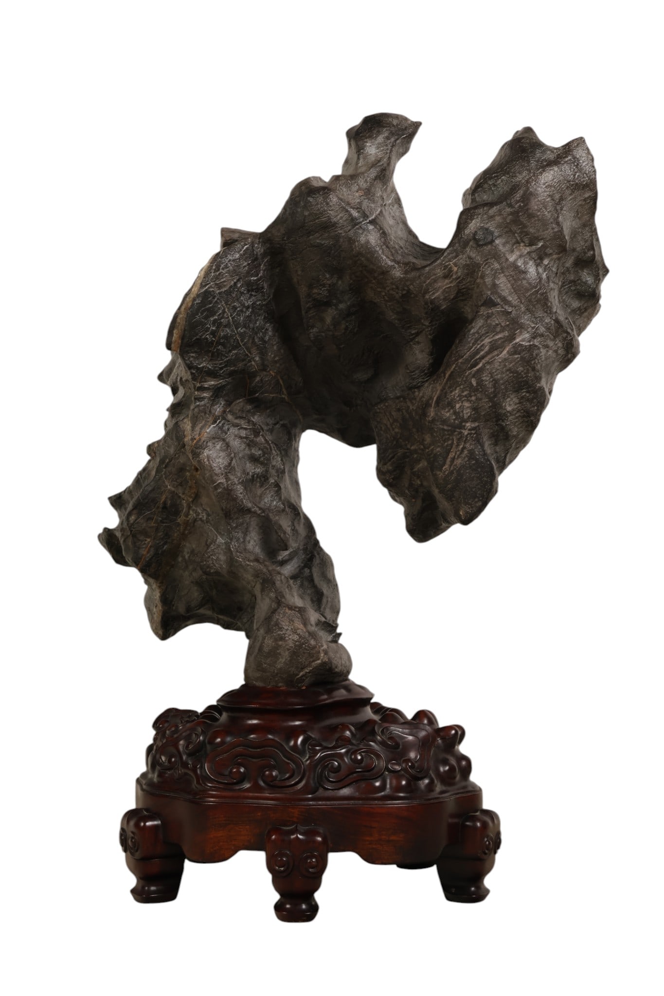 Chinese Gongshi Limestone Scholar's Rock on Stand: Chinese Lingbi limestone gongshi (scholar's stone) mounted on an elaborately carved hardwood base. The naturally formed stone exhibits dramatic contours, voids, and richly textured surfaces prized in