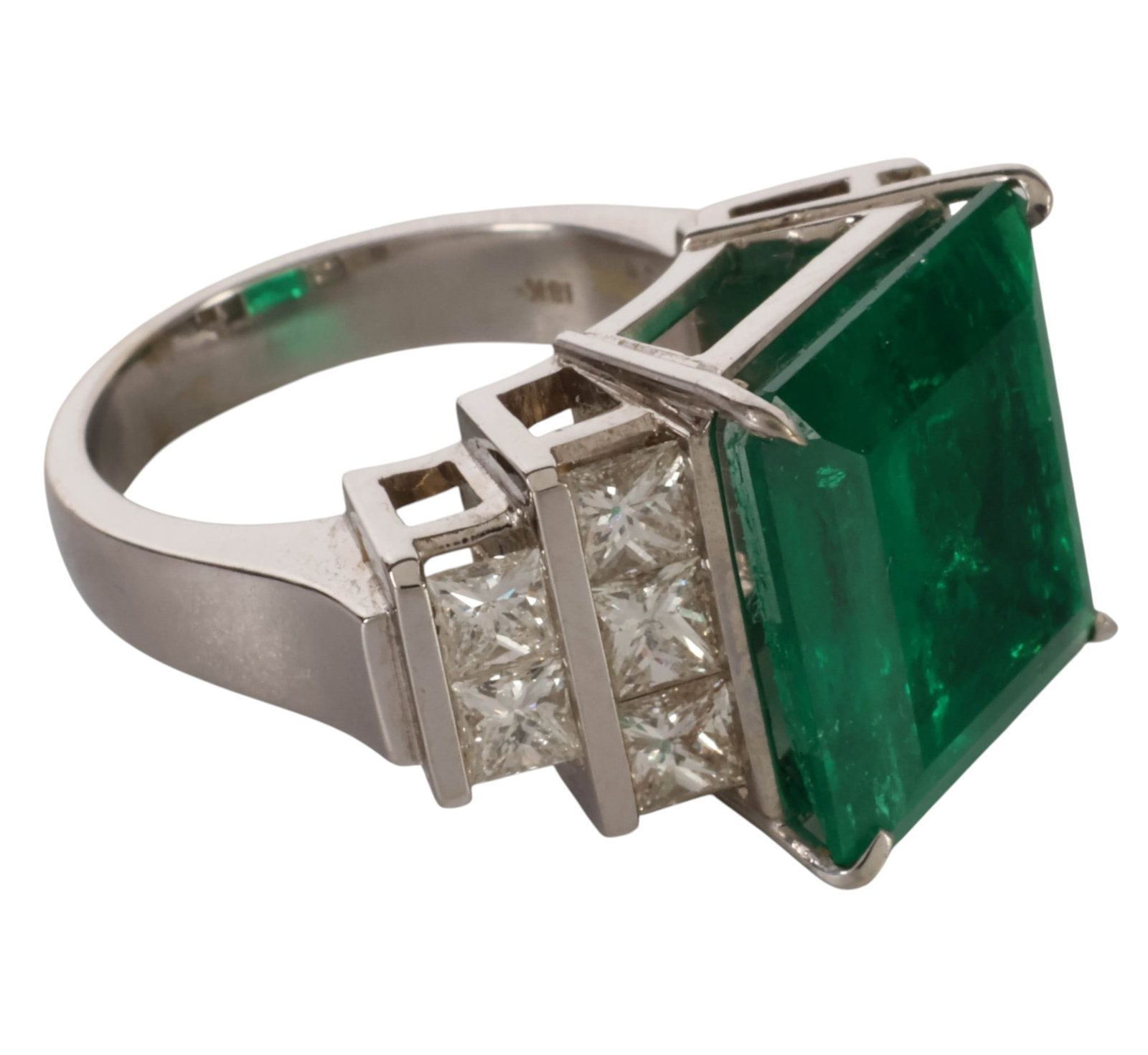 18K Gold 10.58 CT Emerald Diamond Cocktail Ring: 18K white gold emerald and diamond cocktail ring centered by a large emerald-cut natural emerald weighing approximately 10.58 carats and measuring approximately 14.8 x 14.0 x 8.2 mm. The emerald is de