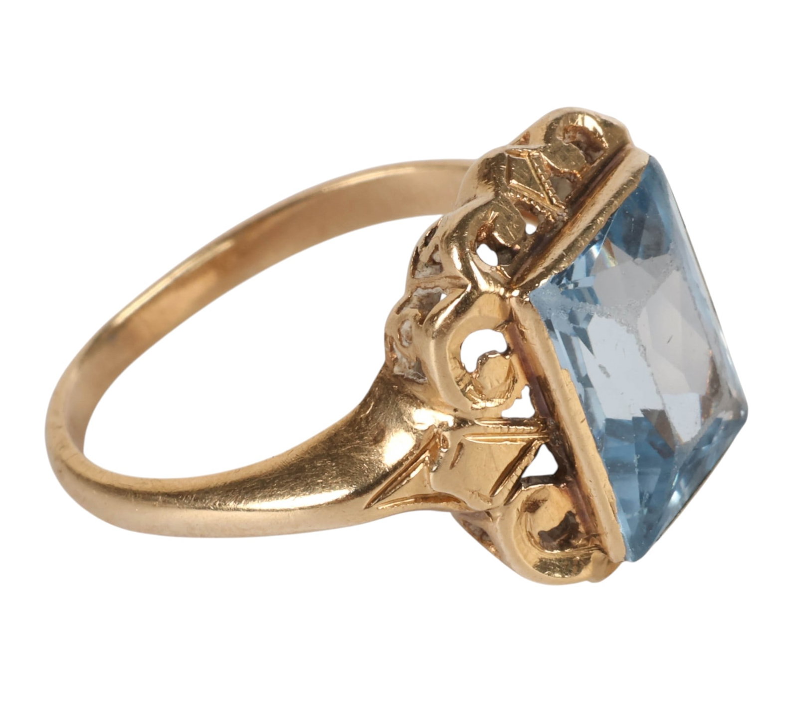 14k Gold Filigree Blue Gemstone Size 6.5 Ring 3.4g: Vintage 14K yellow gold ring centering an emerald-cut light blue gemstone within an openwork filigree-style mounting, accented by small clear stones along the shoulders. Stamped 14K. Ring size: 6.5. A