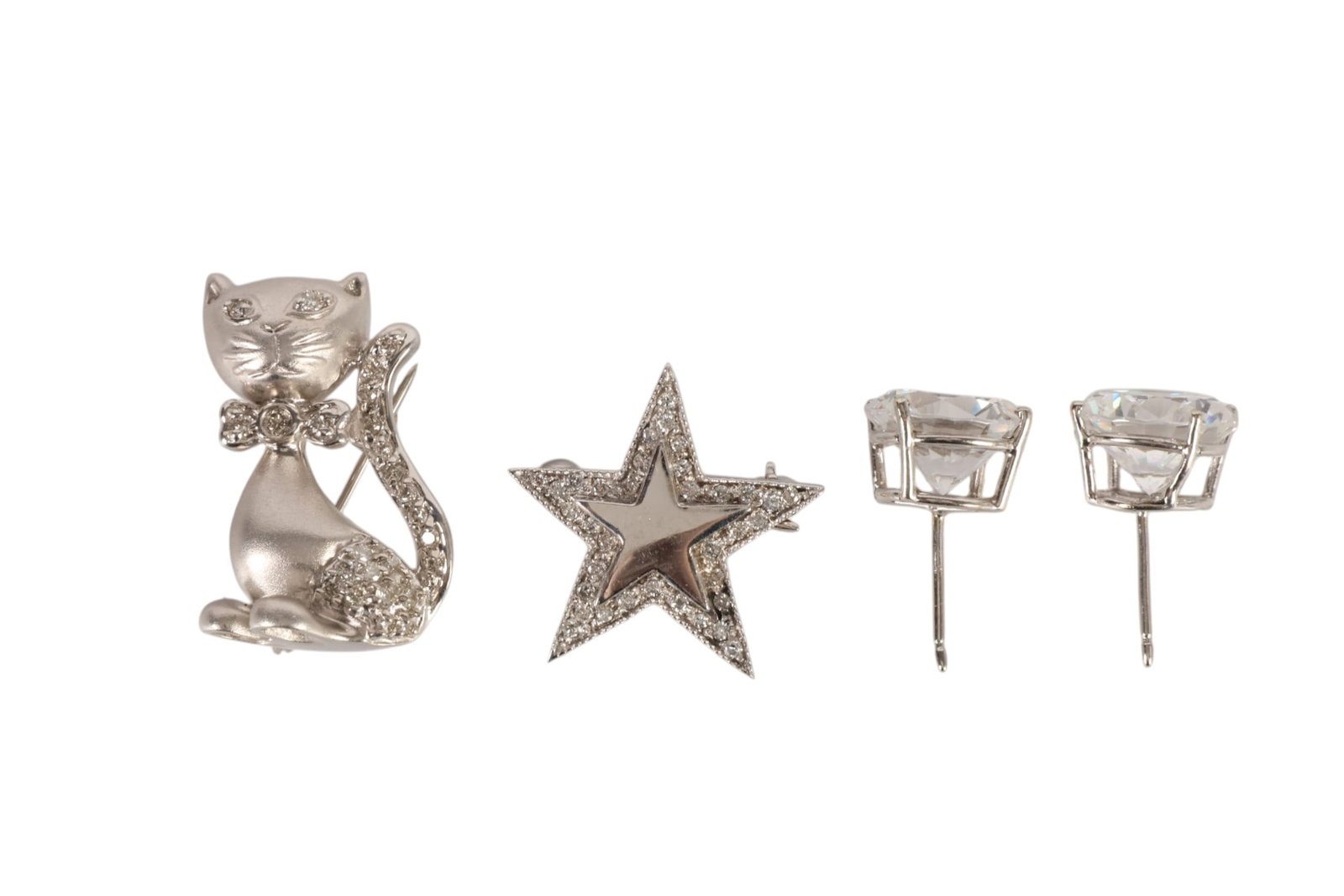 14K White Gold Cat and Star Pins & CZ Earrings LOT: Lot of 14K white gold jewelry comprising a sculptural cat brooch accented with round diamonds along the tail and body and fitted with a pin stem and small bail; a diamond-accented star brooch; and a p