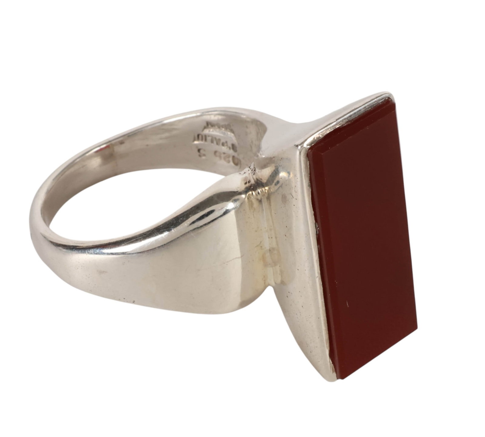 William Spratling Sterling Silver & Carnelian Ring: William Spratling (American, 1900-1967), Taxco sterling silver and carnelian ring, featuring a bold modernist setting centered by a rectangular polished deep reddish-brown hardstone, measuring approxi
