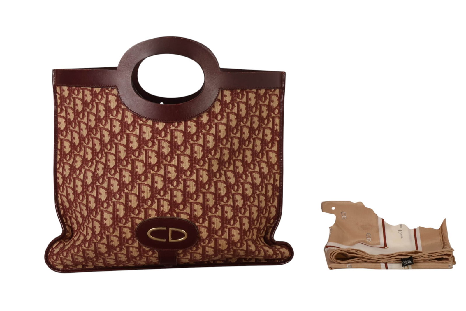 Christian Dior Vintage Shopper Purse & Silk Scarf: Two-piece vintage Christian Dior fashion accessories lot comprising a burgundy and beige Dior monogram canvas tote with dark burgundy leather trim, matching interior, integrated oval handles, and a sl