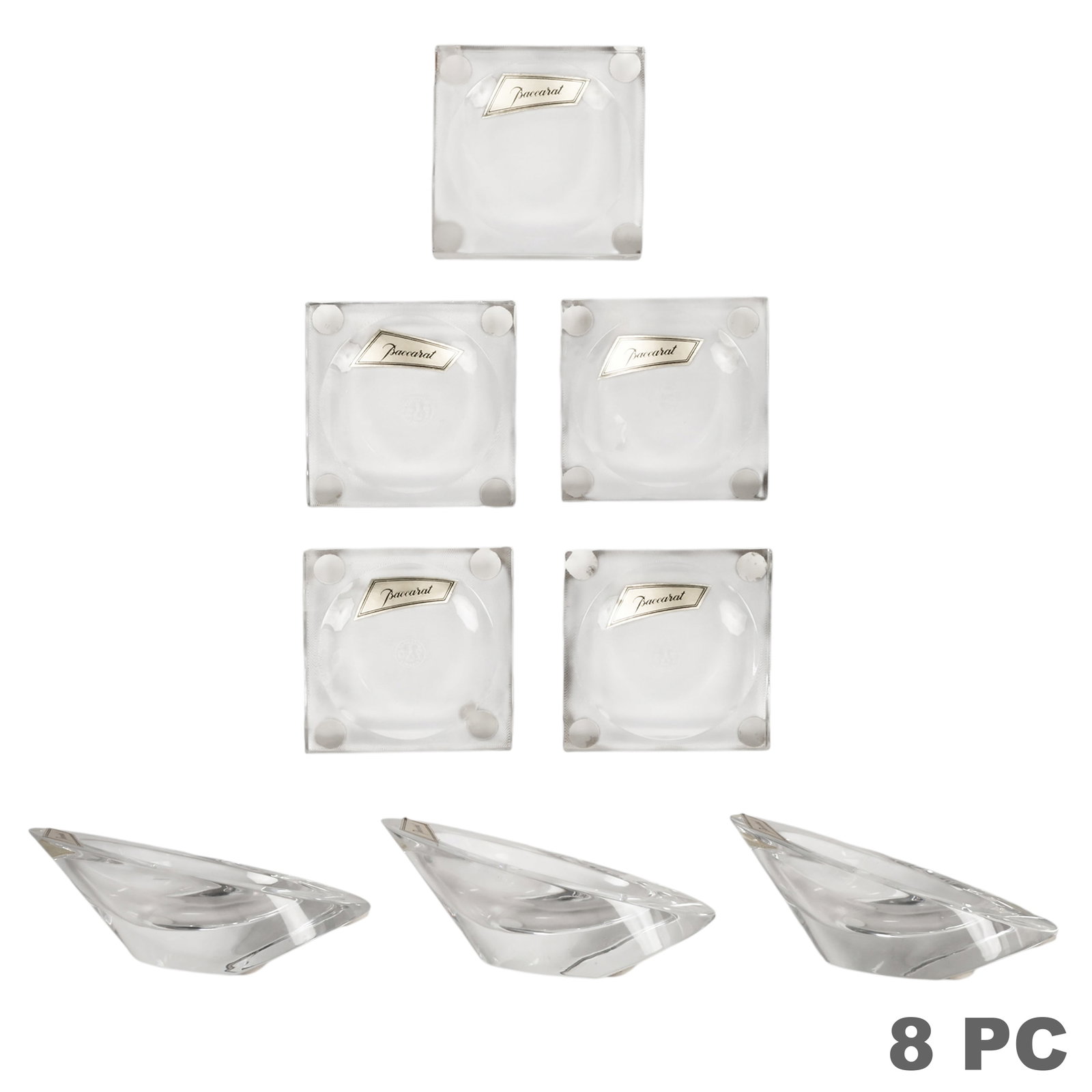 Baccarat Crystal Holders & Trays Gift Ware 8pc LOT: Baccarat eight-piece French clear crystal giftware collection comprising three freeform sculptural pipe holders and five square mini ashtrays, each accompanied by a branded red Baccarat box. Select pi