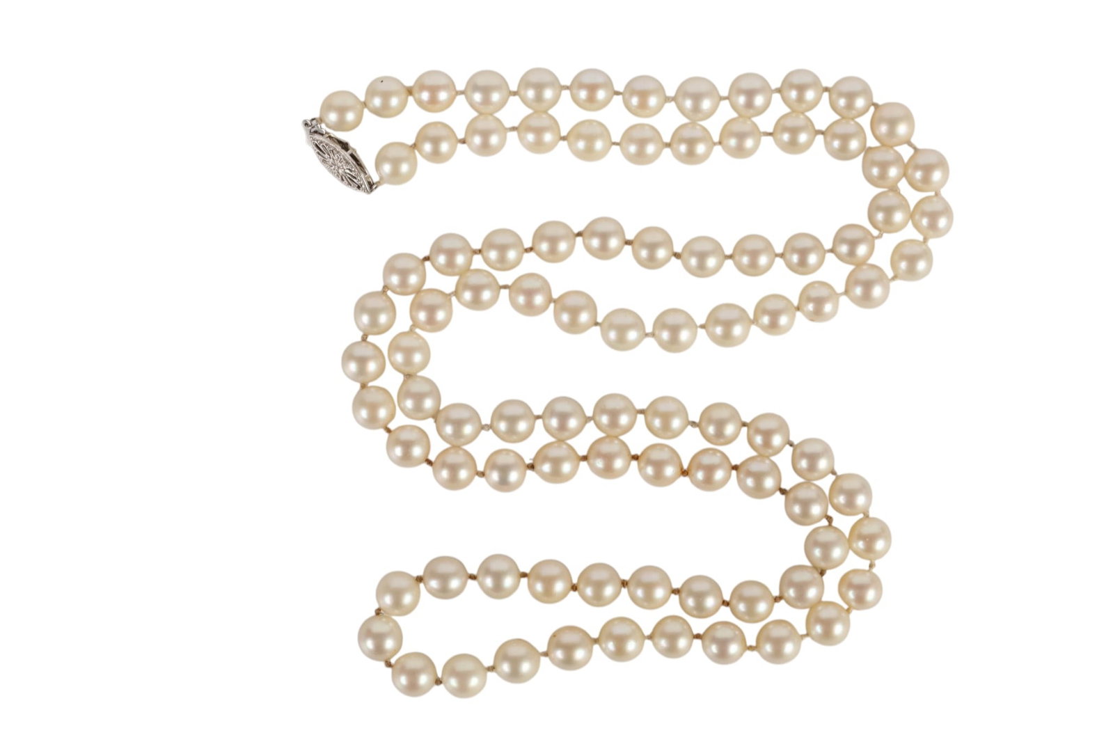 14k White Gold 7mm Akoya Pearl 34" Necklace 60g.: Vintage cultured Akoya pearl necklace composed of cream-white pearls measuring approximately 7 mm each, individually knotted and finished with an ornate pierced 14K white gold clasp. Necklace measures