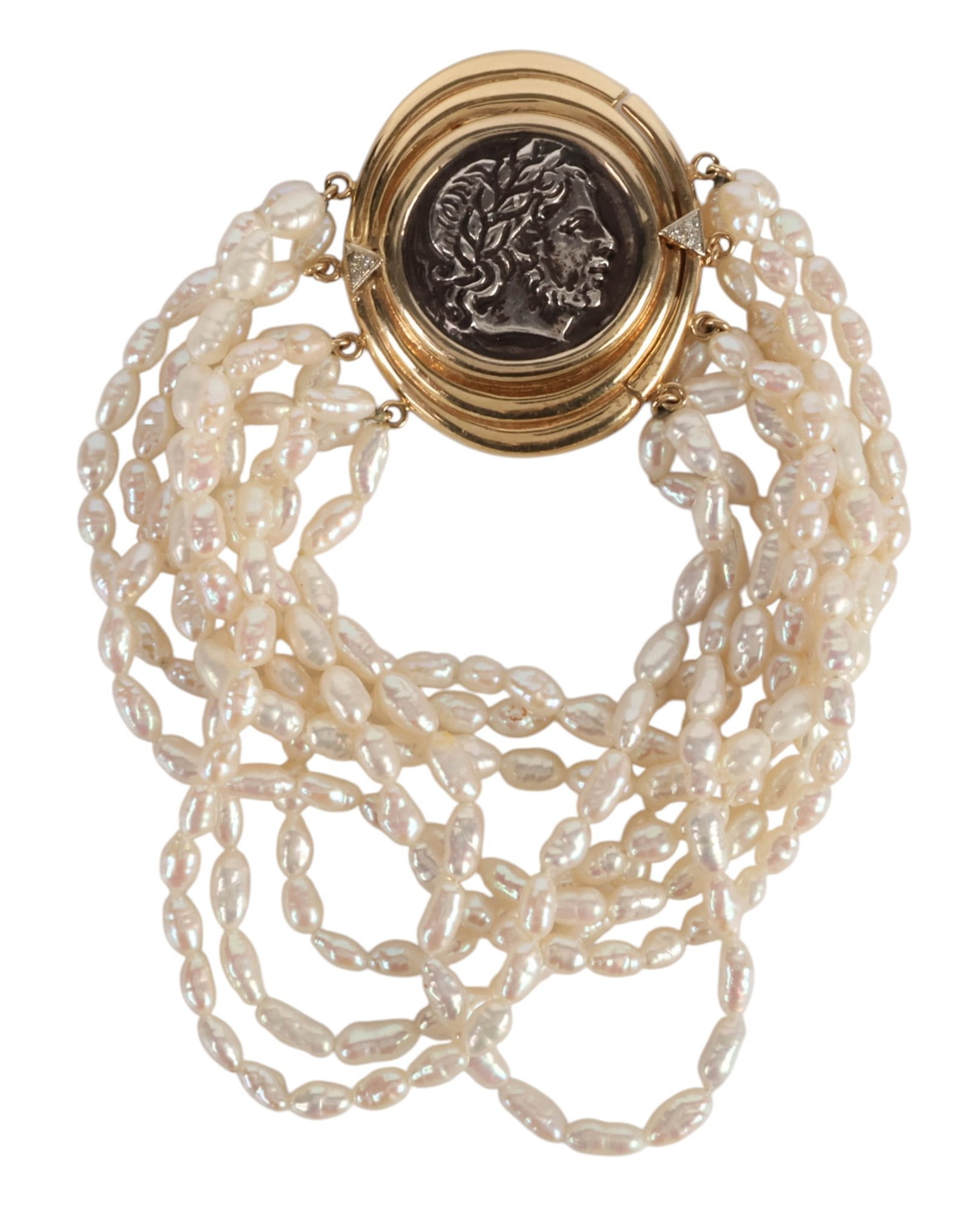 14K Multi-Strand Rice Pearl Hellenistic Bracelet: Vintage multi-strand freshwater rice pearl bracelet composed of pearls measuring approximately 4 x 6 mm, fitted with a distinctive circular 14K yellow gold clasp centered by a 925 silver Hellenistic c