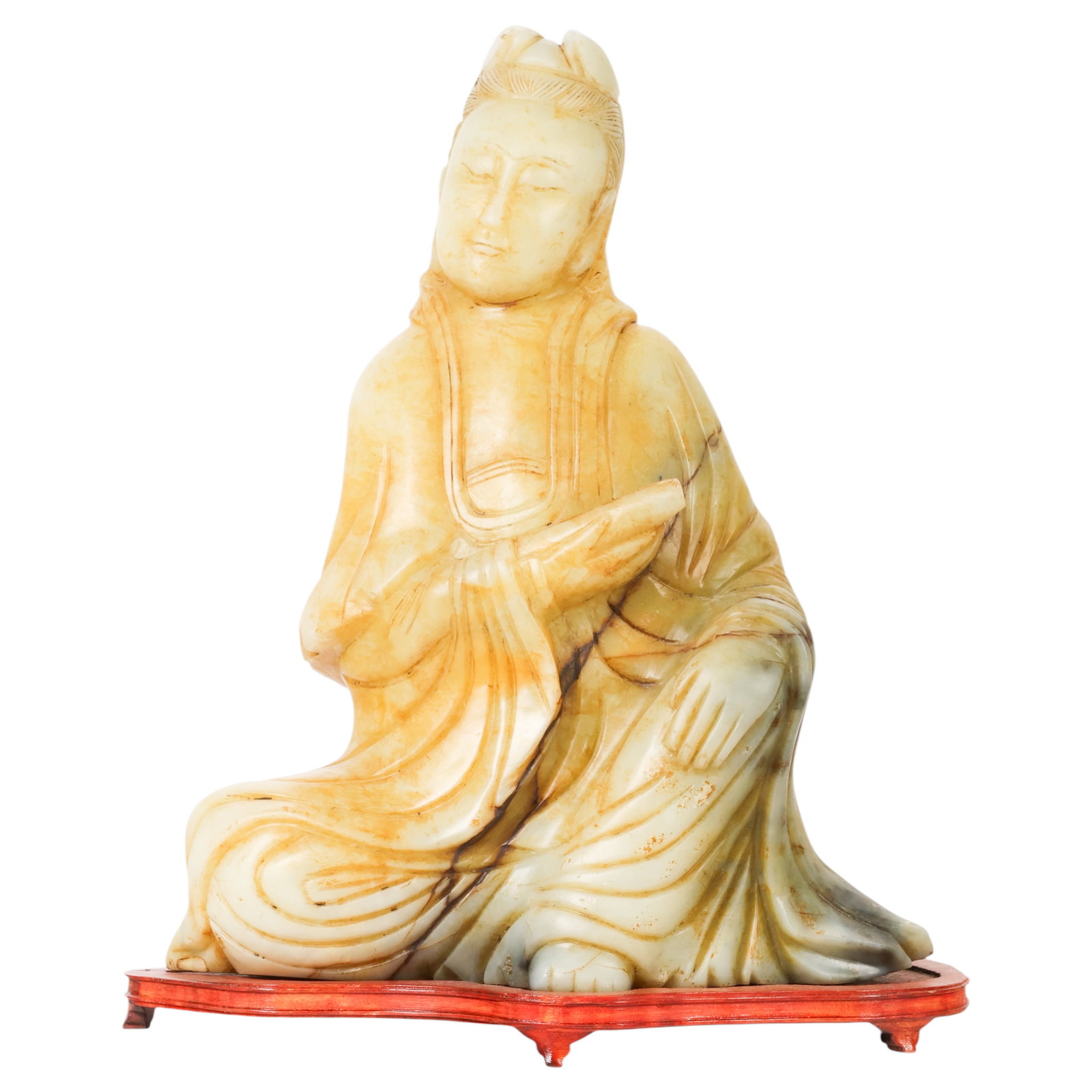 Chinese Carved Natural Hardstone Buddha Sculpture: Chinese carved stone Buddha sculpture depicting a seated robed figure in a contemplative pose with one arm raised across the torso. Executed in polished variegated stone displaying cream, honey, and o