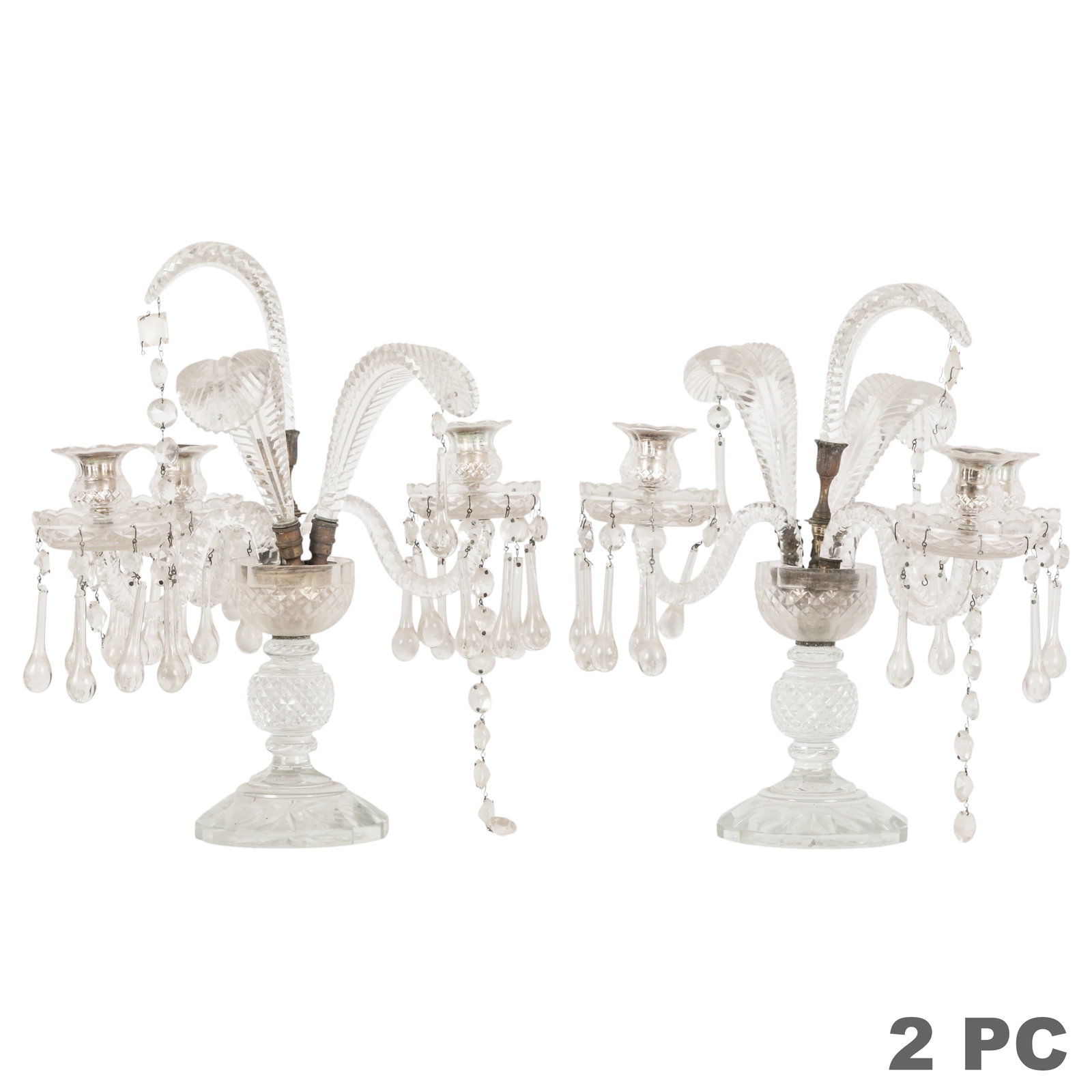 Antique Pair of Crystal Three-Light Candelabras: Pair of cut crystal three light candelabras, each featuring a faceted crystal stem and base supporting scrolling crystal arms, prism drops, and foliate form crystal finials. The candle cups are fitted