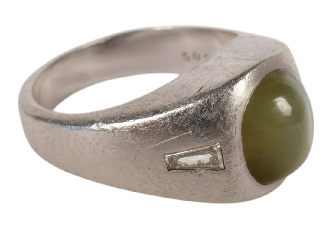 Men's Platinum Diamond Cats Eye Chrysoberyl Ring: Platinum, a mens antique ring set with an oval cabochon cats eye chrysoberyl measuring approximately 8.5 mm x 7 mm accented by two tapered diamonds measuring approximately 2 mm x 1.5 mm each. Interior