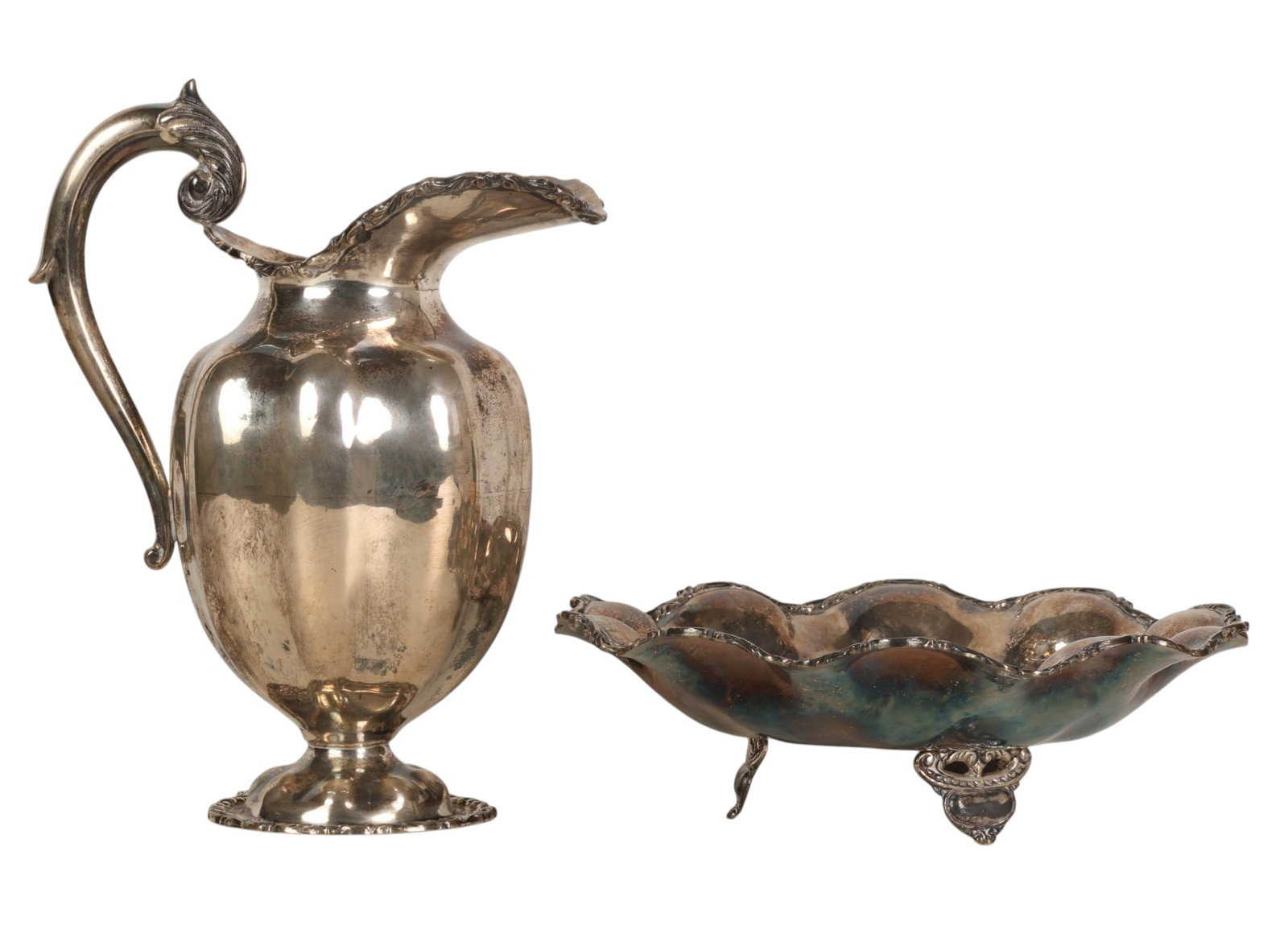 Sterling Silver Bowl and Water Pitcher 1,885g.: Two piece lot of sterling silver table articles, comprising a footed water pitcher and matching footed bowl. The pitcher features a bulbous body rising to a flared scalloped rim and is fitted with a d