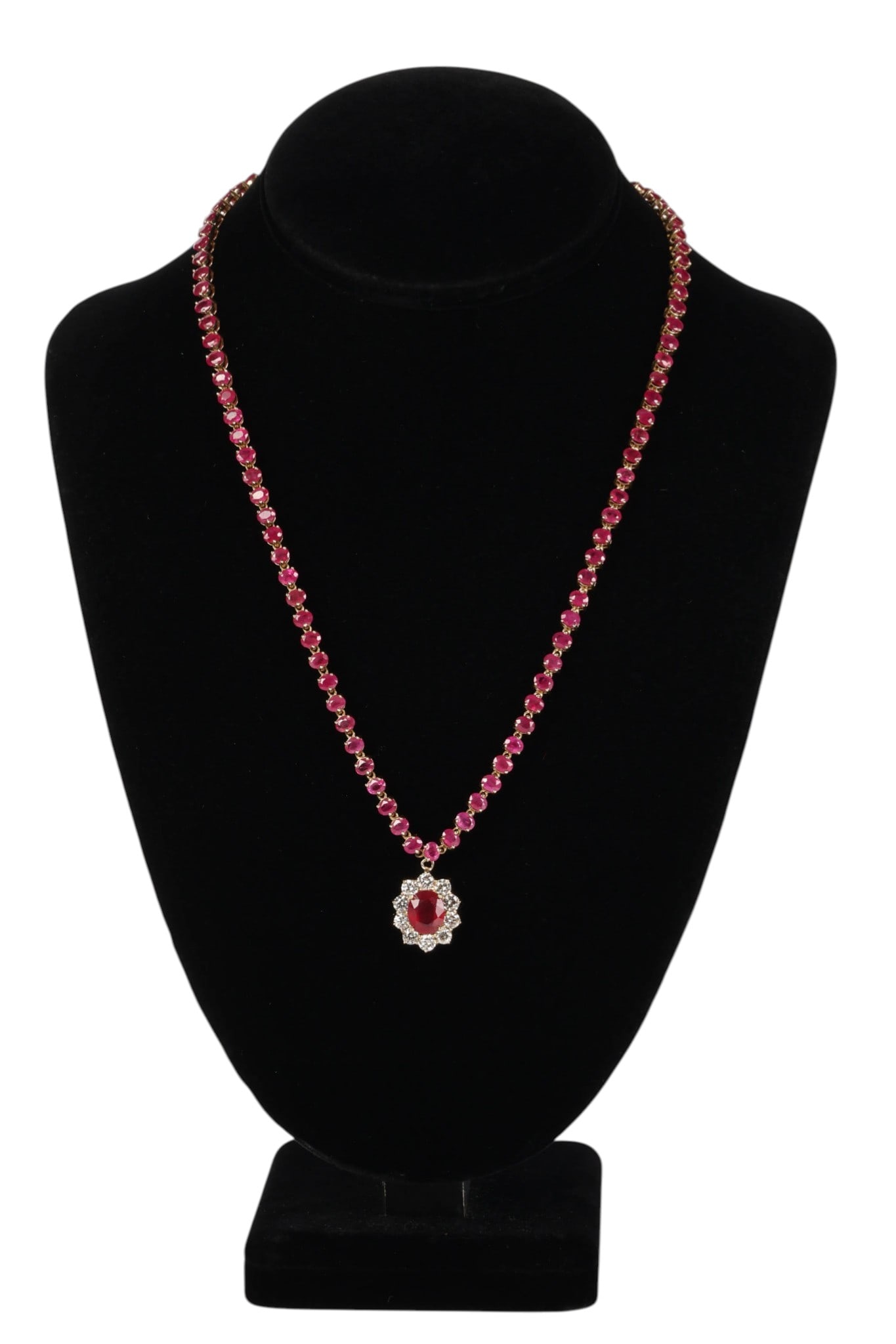 14K Ruby Tennis Necklace with Diamond Ruby Pendant: 14K yellow gold ruby and diamond necklace featuring round rubies set along the tennis-style chain totaling approximately 11 carats combined. The center pendant is set with an oval ruby weighing approx