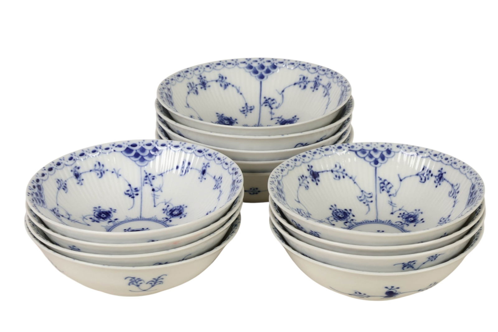 Royal Copenhagen Blue Fluted Half Lace Cereal Bowl: Royal Copenhagen Denmark, a set of thirteen Danish porcelain Blue Fluted Half Lace Border pattern coupe cereal bowls. The decoration is characterized by a hand painted cobalt blue floral motif, lace l