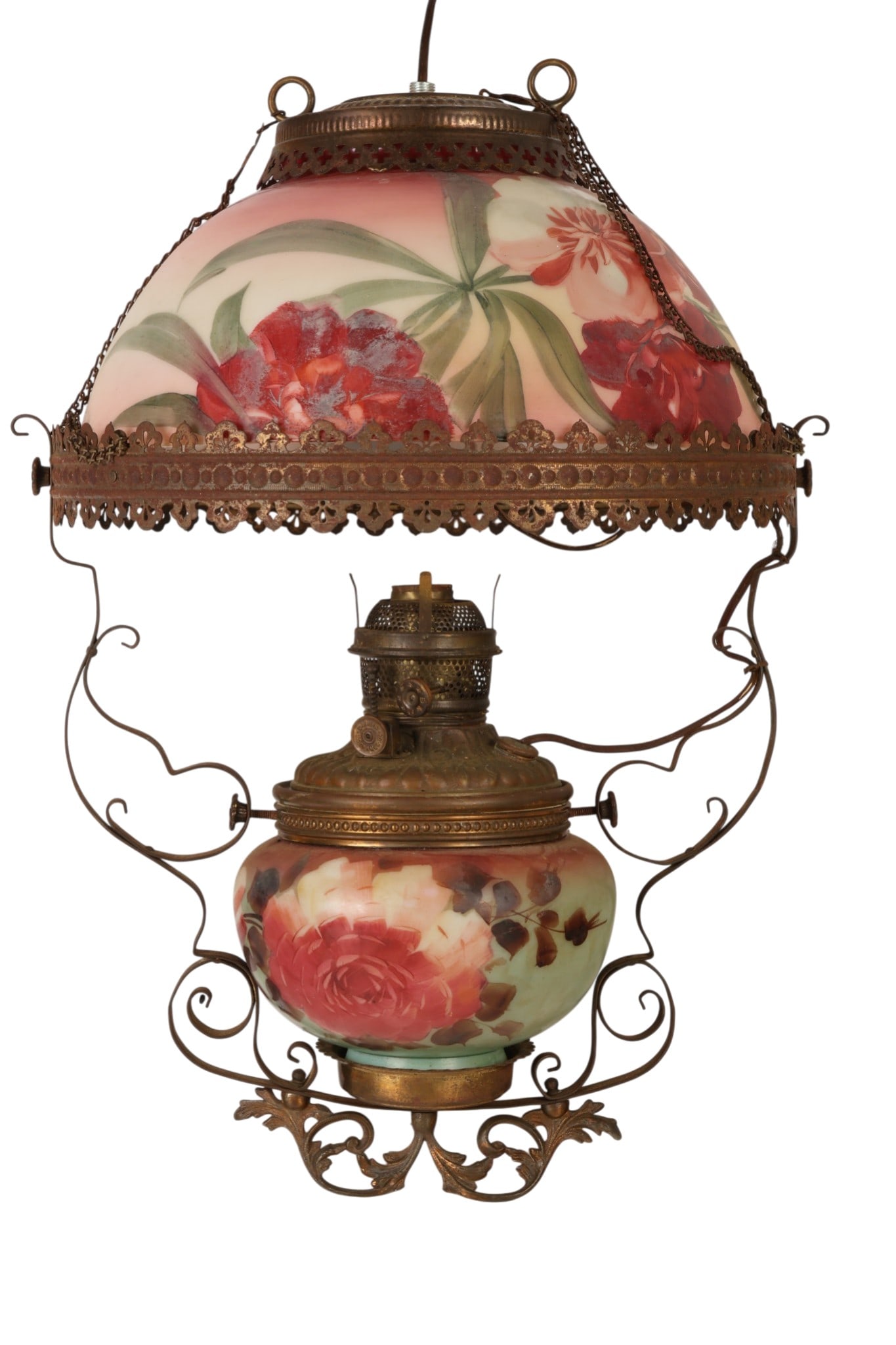 Antique Hand Painted Parlor Electrified Oil Lamp: Antique Victorian parlor lamp featuring a hand-painted glass font decorated with a floral motif on a frosted ground, later electrified. The lamp is mounted in a pierced and embossed metal frame with s