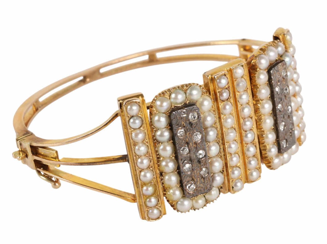 Antique 15K Gold Diamond Seed Pearl Bracelet: Early 19th century 15k English gold hinged bangle bracelet. Features an Etruscan revival style with the top of the bracelet adorned with diamonds set in silver, and seed pearls set in rows and encircl