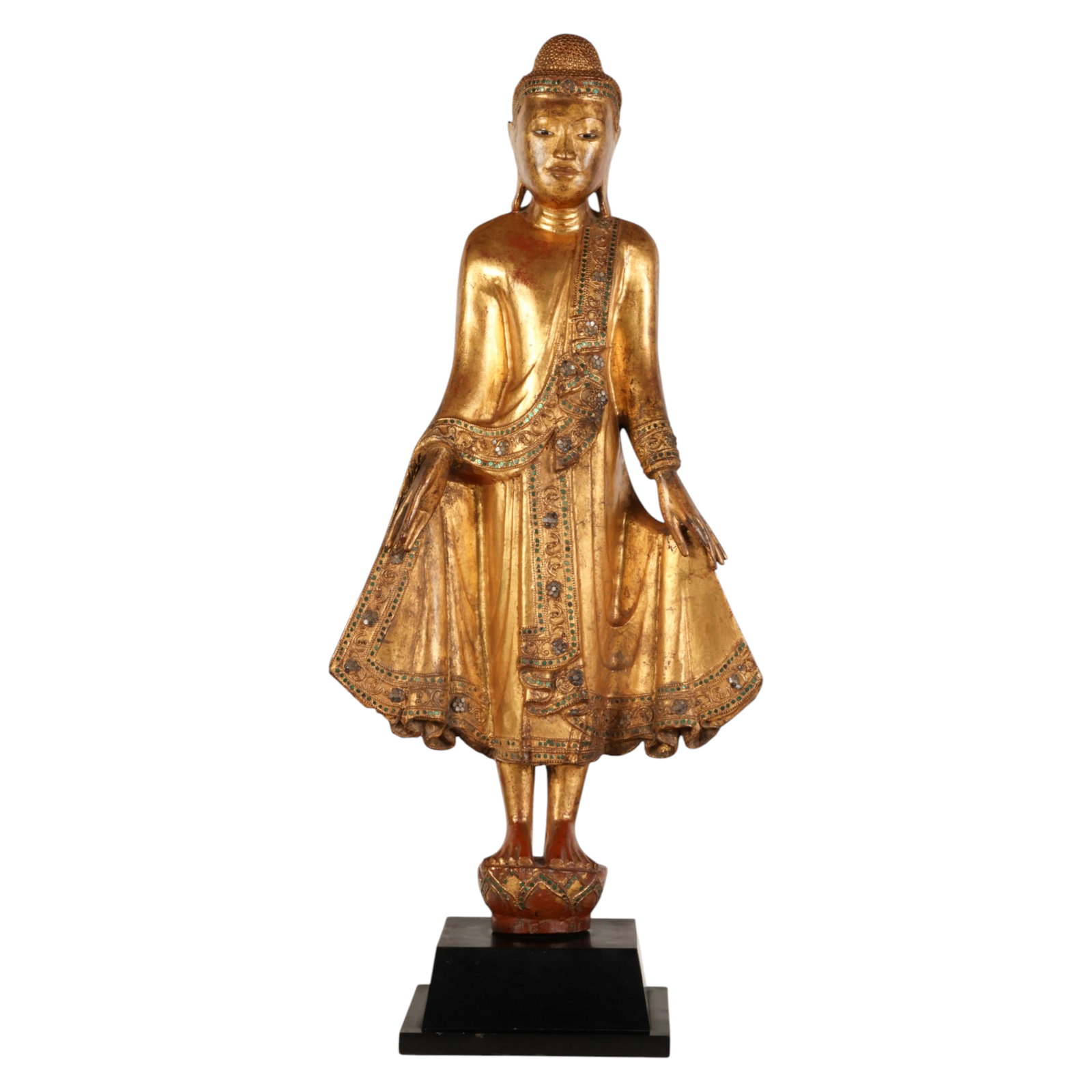 Antique Mandalay Style Gilt Wood Standing Buddha: Mandalay style gilt wood, an antique Asian hand carved sculpture depicting a standing Buddha deity modeled in traditional pose upon a red lacquered lotus platform and elevated on a black stepped wood