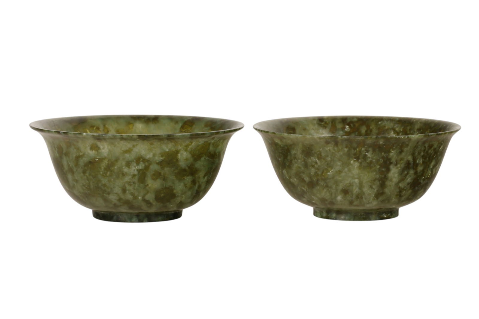 Chinese Pr Bowenite Translucent Green Stone Bowls: A pair of Chinese carved Bowenite stone bowls each displaying mottled veining in olive and darker tonal variations throughout the natural matrix. Each example is formed with a circular rim, rounded wa