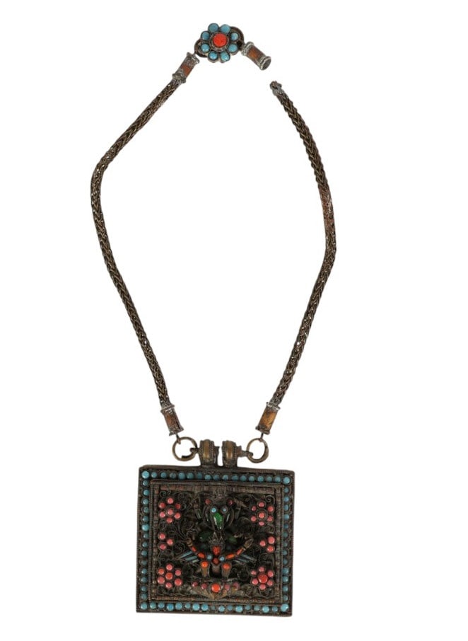 Tibetan Turquoise Coral Inlay Prayer Box Necklace: Antique Tibetan prayer box-style necklace featuring a woven metal chain and a large square pendant. The pendant is decorated with applied metal filigree and a raised figural motif at the center depict