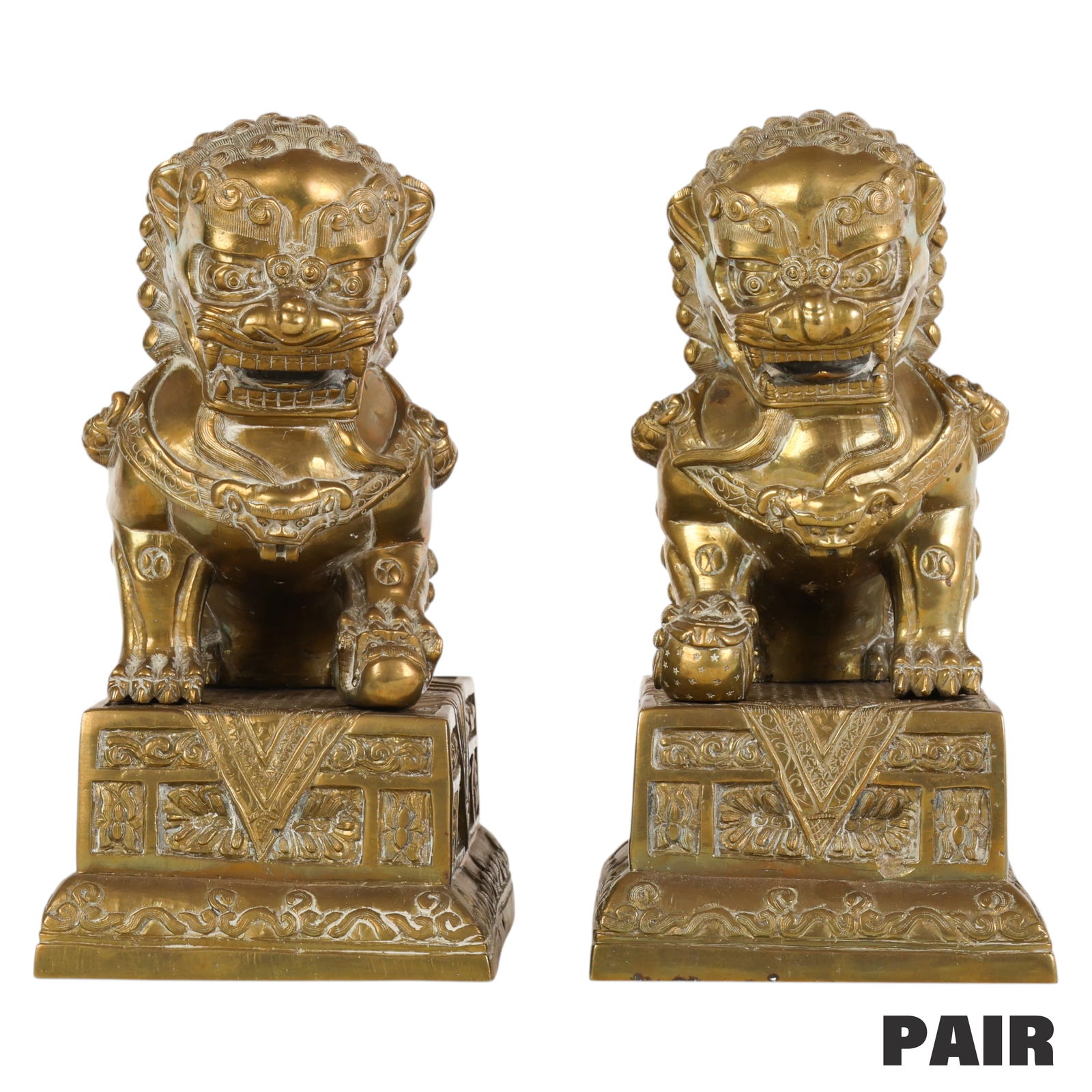 Chinese Ming Dinasty Pair of Brass Guardian Lions: Chinese Ming Dinasty, a pair of cast and polished brass foo dog lion figures each seated atop a separately cast square pedestal with decorative relief motifs. The traditional male and female symbolic